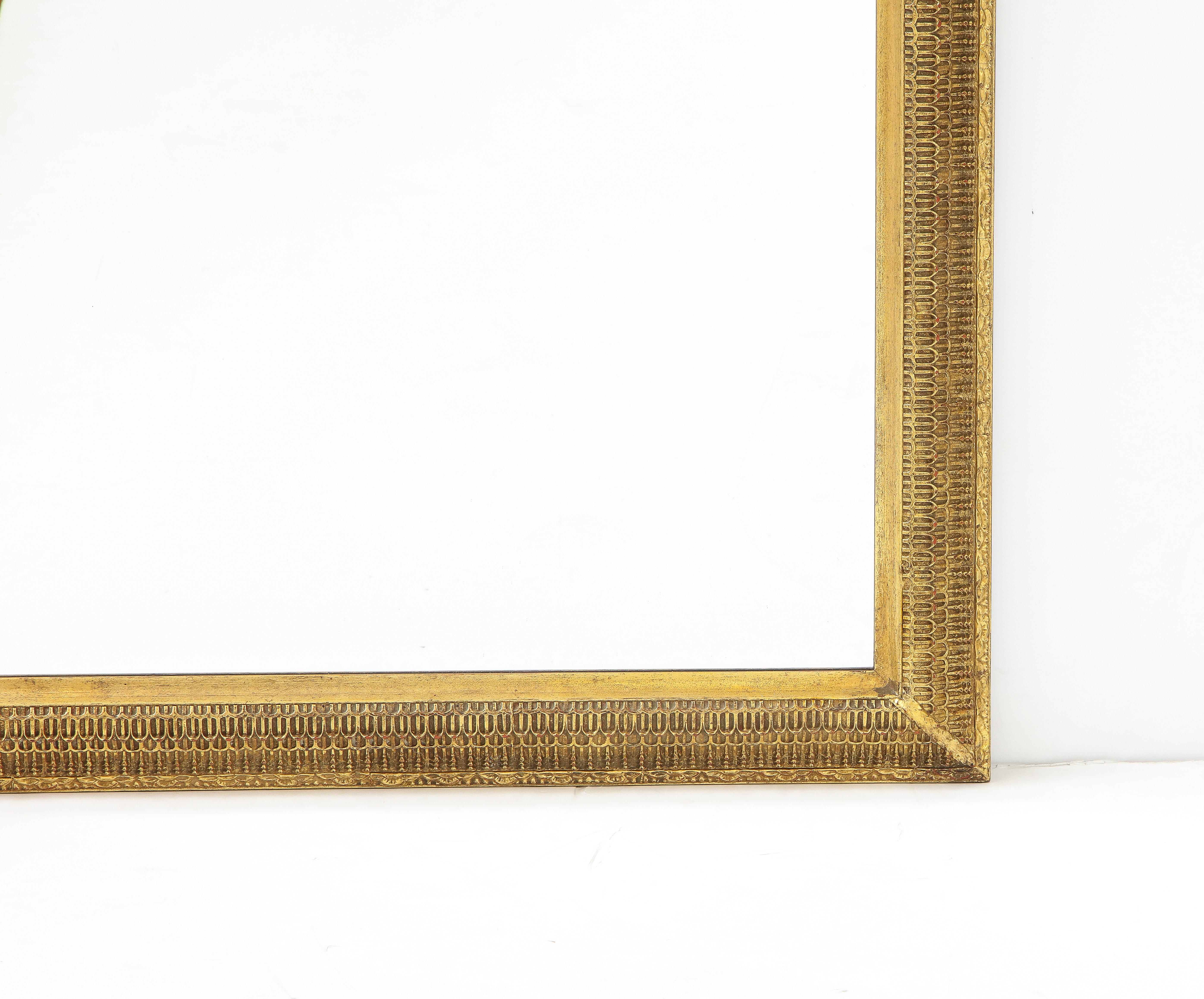 1950's Hollywood Regency style gilt-wood wall mirror by D.Milch & Son, in vintage original condition with minor wear and patina due to age and use.