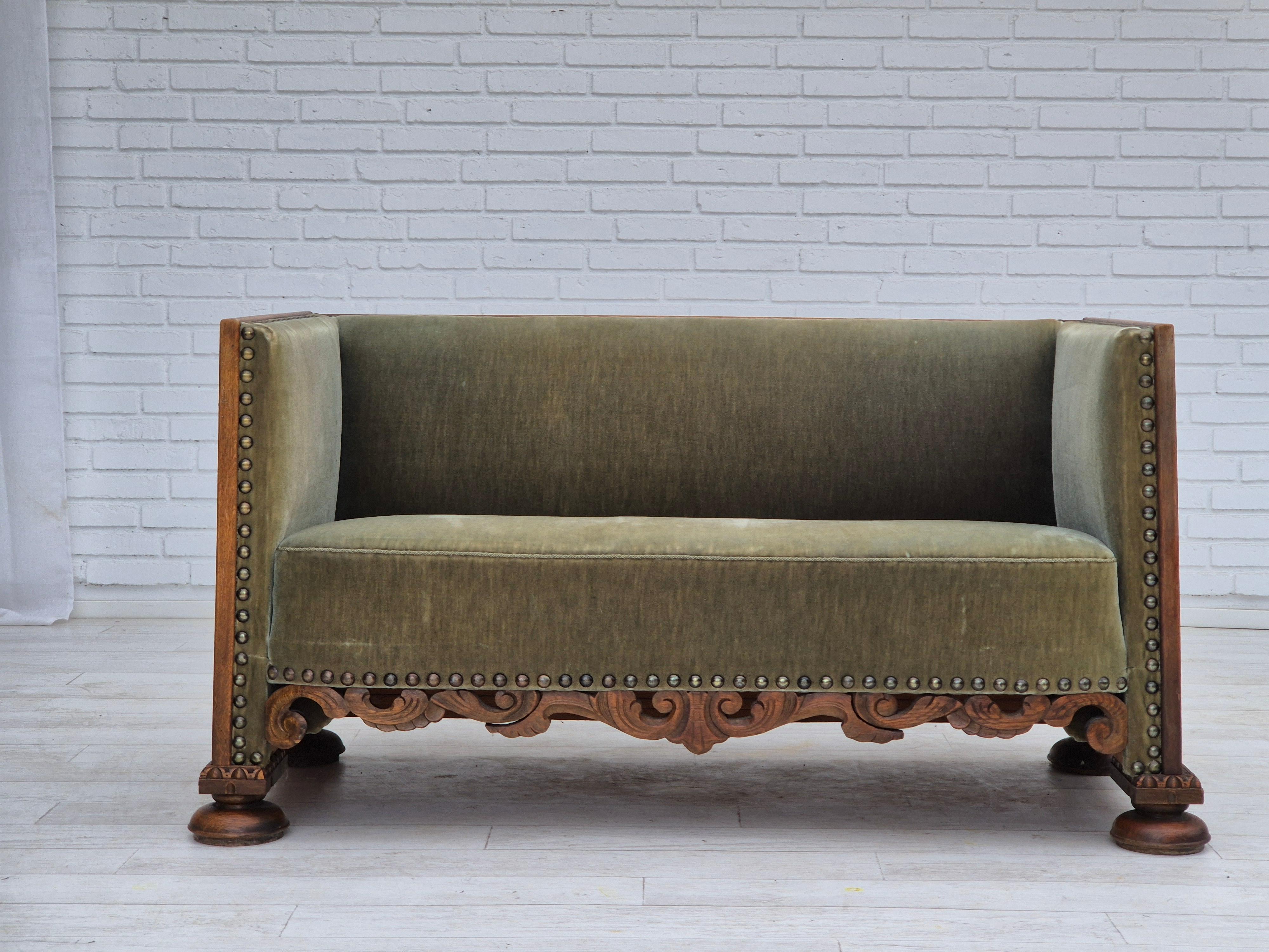 1950s, Danish 2 seater sofa in original good condition: no smells and no stains. Light green furniture velour, oak wood. Brass springs in the seat. Manufactured by Danish furniture manufacturer in about 1950-55s.