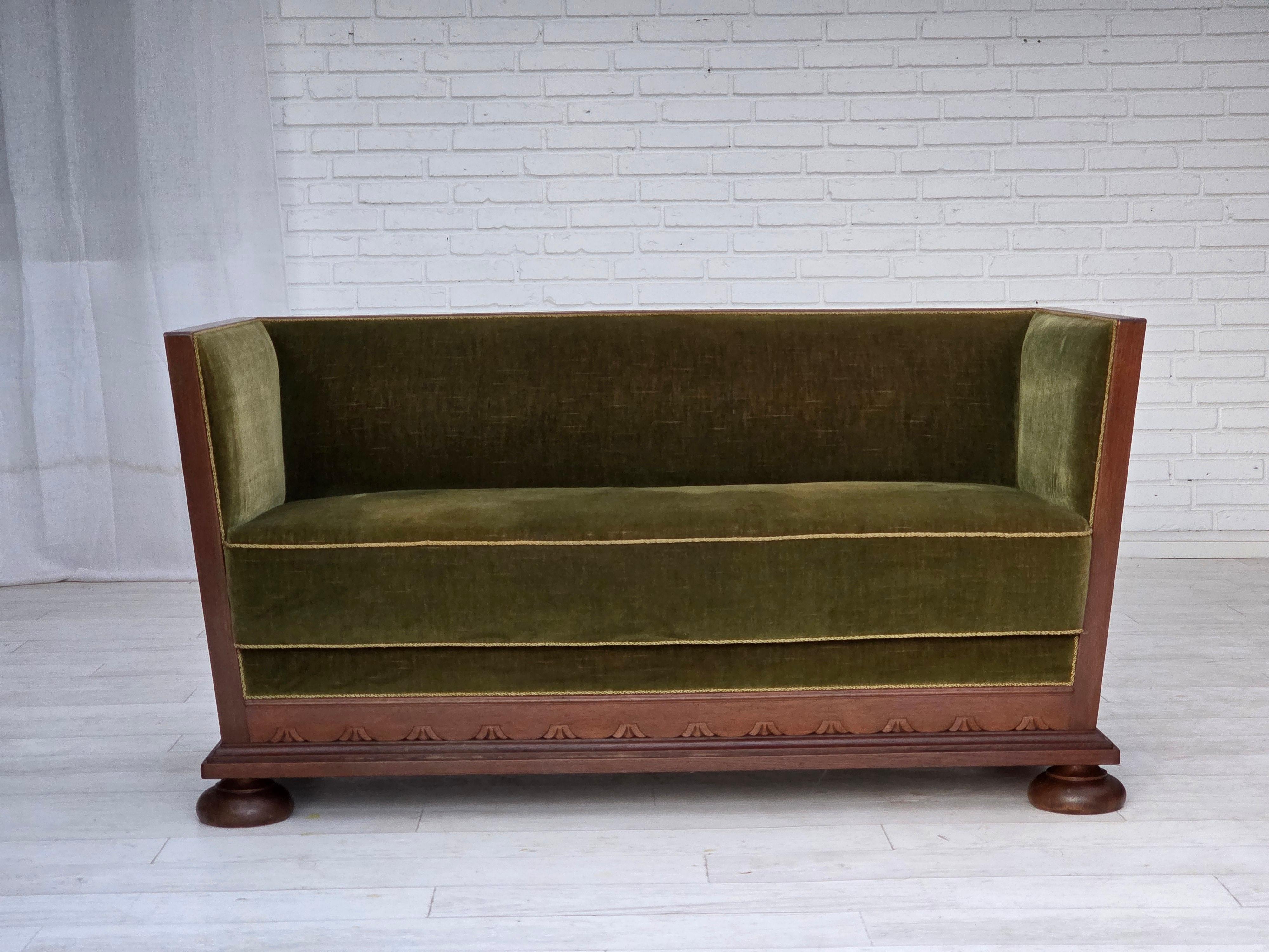 1950s, Danish 2-seater sofa. Original green furniture velour, oak wood, springs in the seat. Original good condition: no smells, no stains and stable construction. Manufactured by Danish furniture maker in about 1955-60s. Original Scandinavian