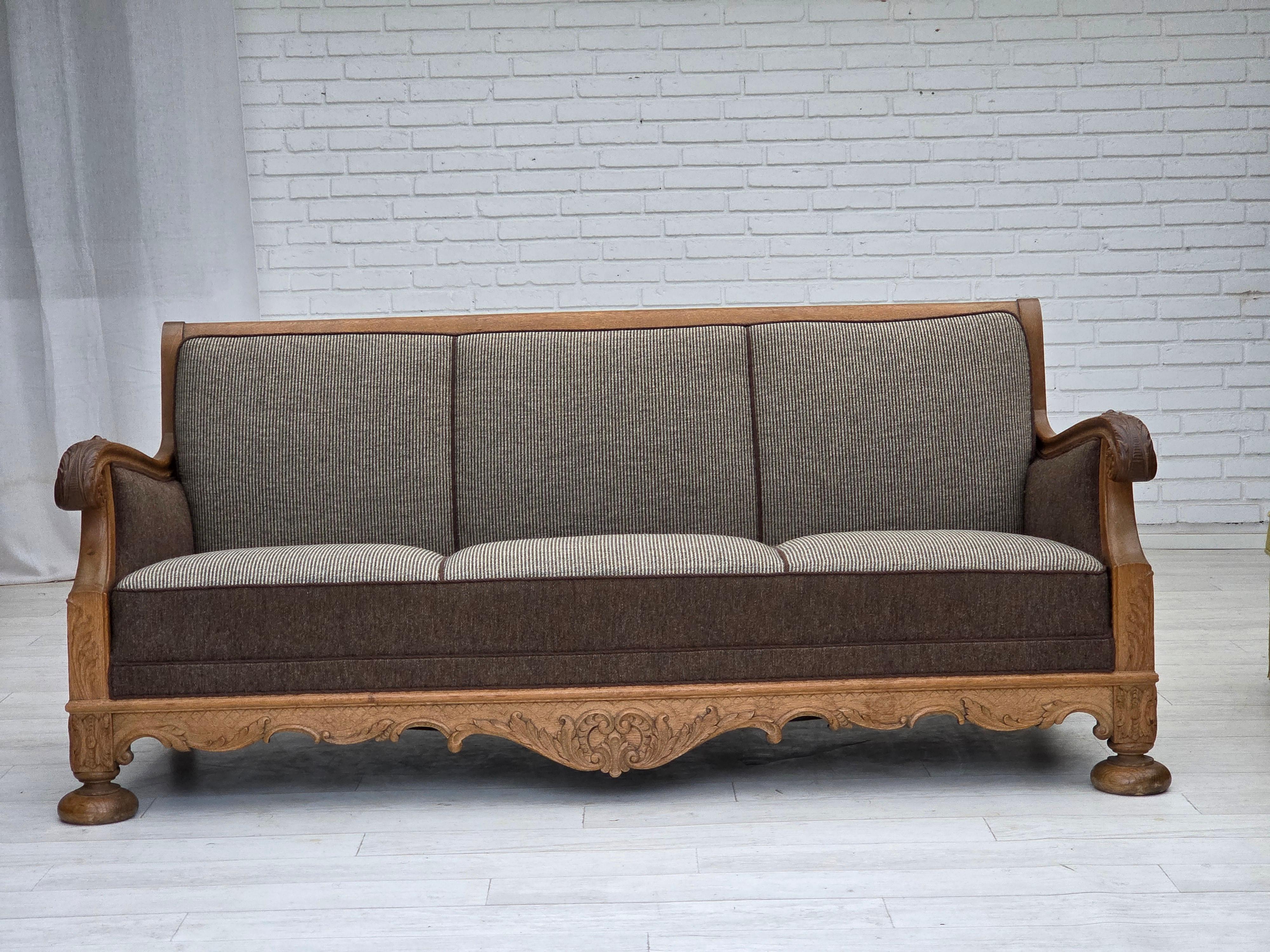 1950s, Danish 3-seater sofa. Furniture wool, solid carved oak wood, brass springs in the seat and back. Sofa was reupholstered about 20 years ago by craftsman. Good condition: no smells, no stains and stable construction. Manufactured by Danish