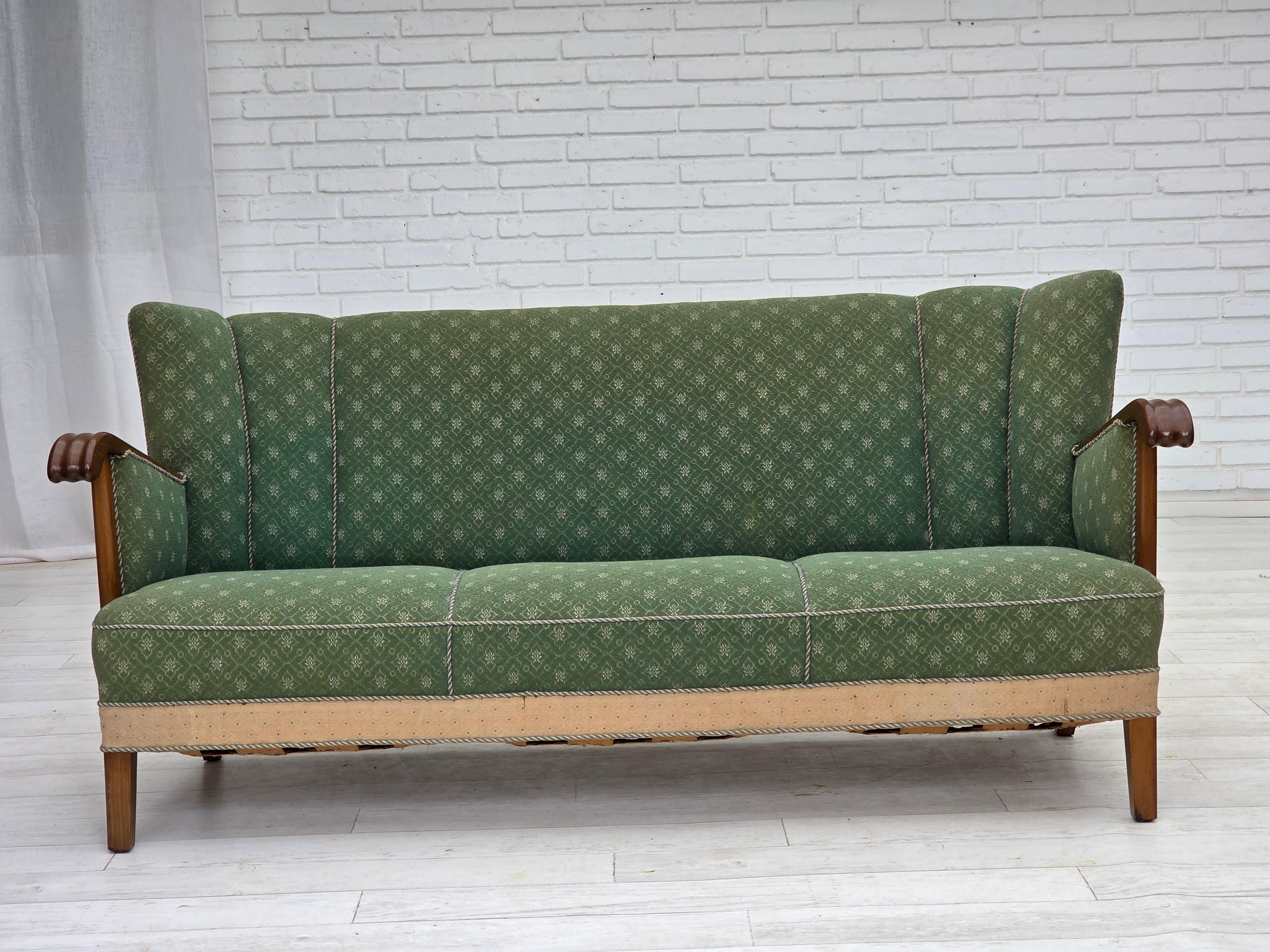 1950s, Danish 3-seater sofa. Original green and beige furniture wool fabric, oak wood, brass springs in the seat. Original good condition: no smells, no stains and stable construction. Sun discoloration of the beige material on the back and sides.