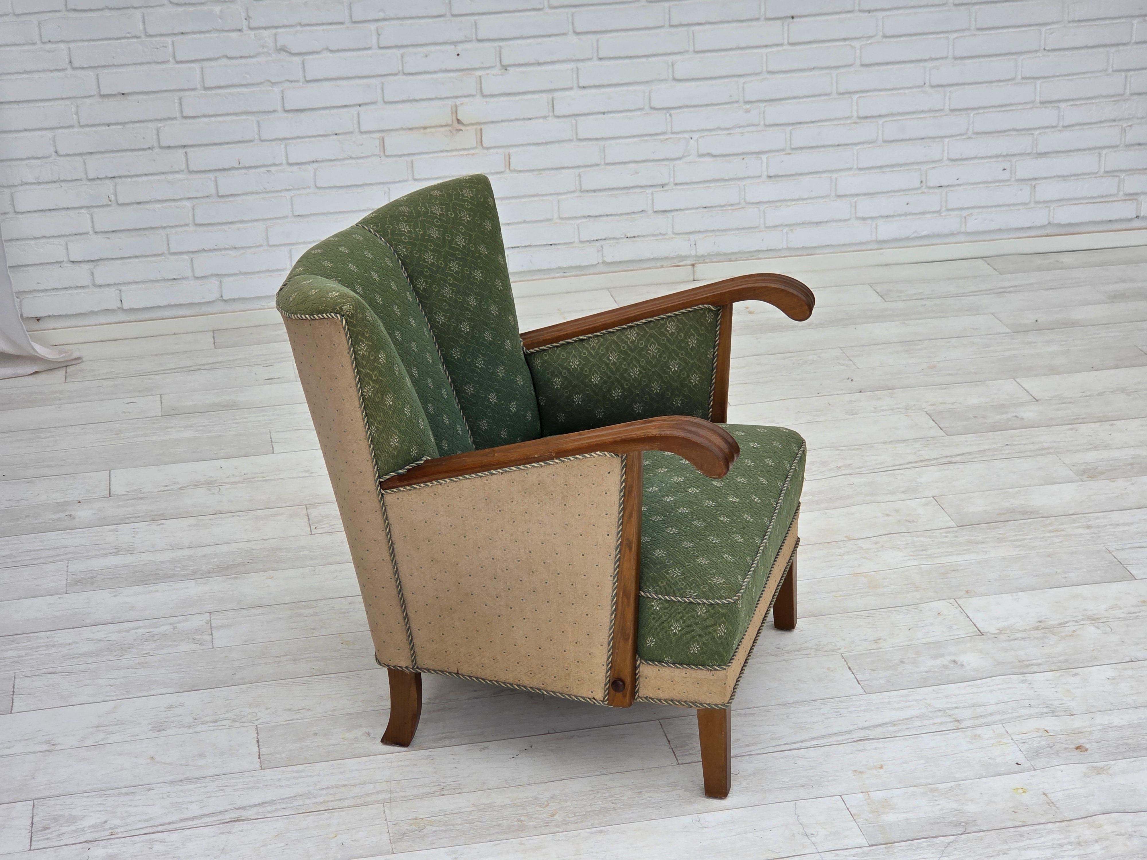 1950s, Danish armchair. Original green and beige furniture wool fabric, oak wood, brass springs in the seat. Original good condition: no smells, no stains and stable construction. Sun discoloration of the beige material on the back and sides.