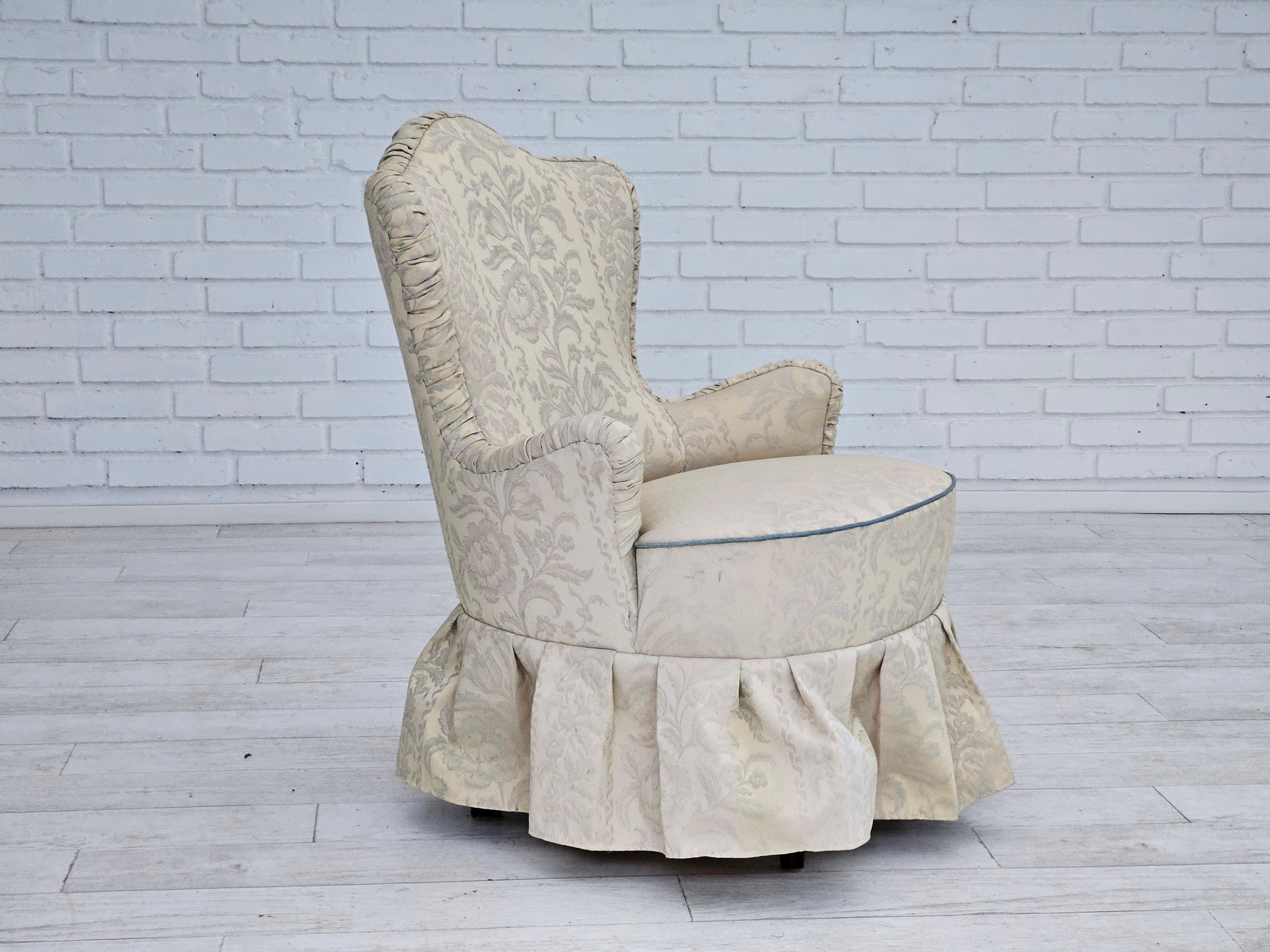 1950s, Danish reupholstered little armchair. Reupholstered in creamy white flowers fabric. Original springs in the seat are kept. Beech wood legs. Manufactured by Danish furniture manufacturer in about 1950.