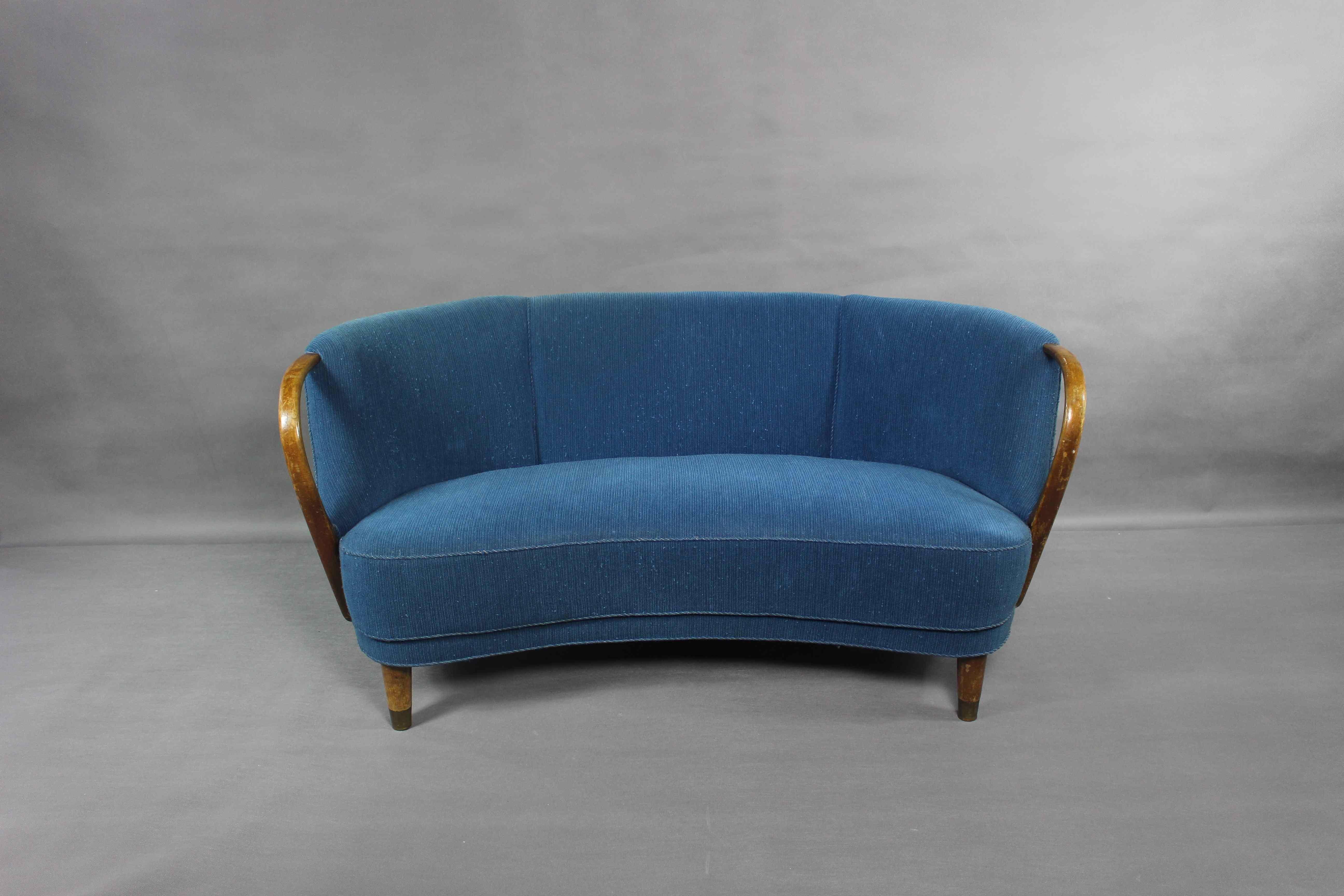 Unique curved or banana shaped loveseat or settee with open armrests designed and made as Model 96 by N.A. Jørgensens Møbelfabrik in 1954/55.

N.A. Jørgensen is better known under the name Bramin Mobler a name they adopted in the 1960s.

