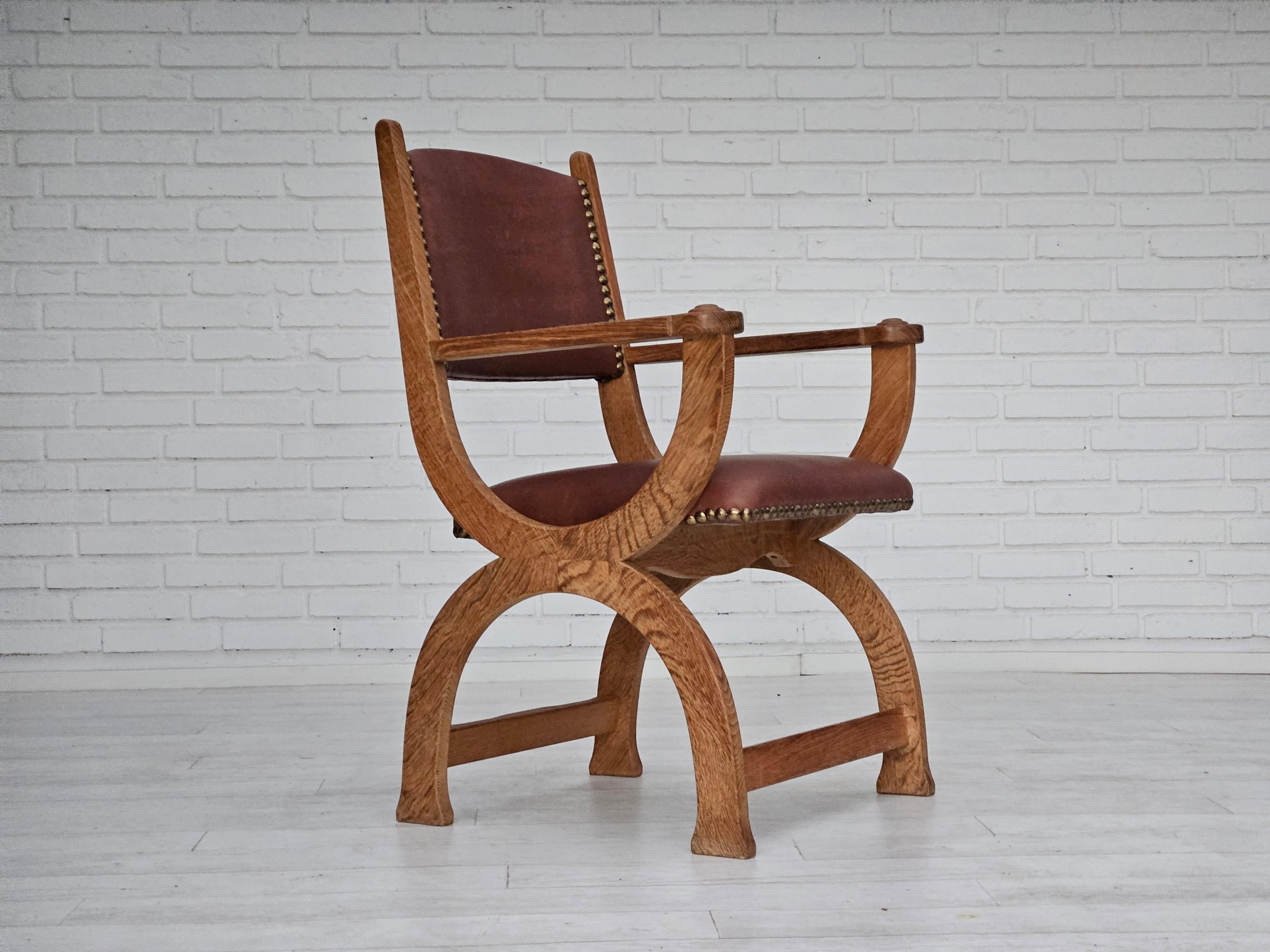 1950s, Danish design. Reupholstered armchair in quality natural brown leather. Renewed oak wood. Manufactured by Danish furniture manufacturer in about 1950s. Reupholstered by craftsman.