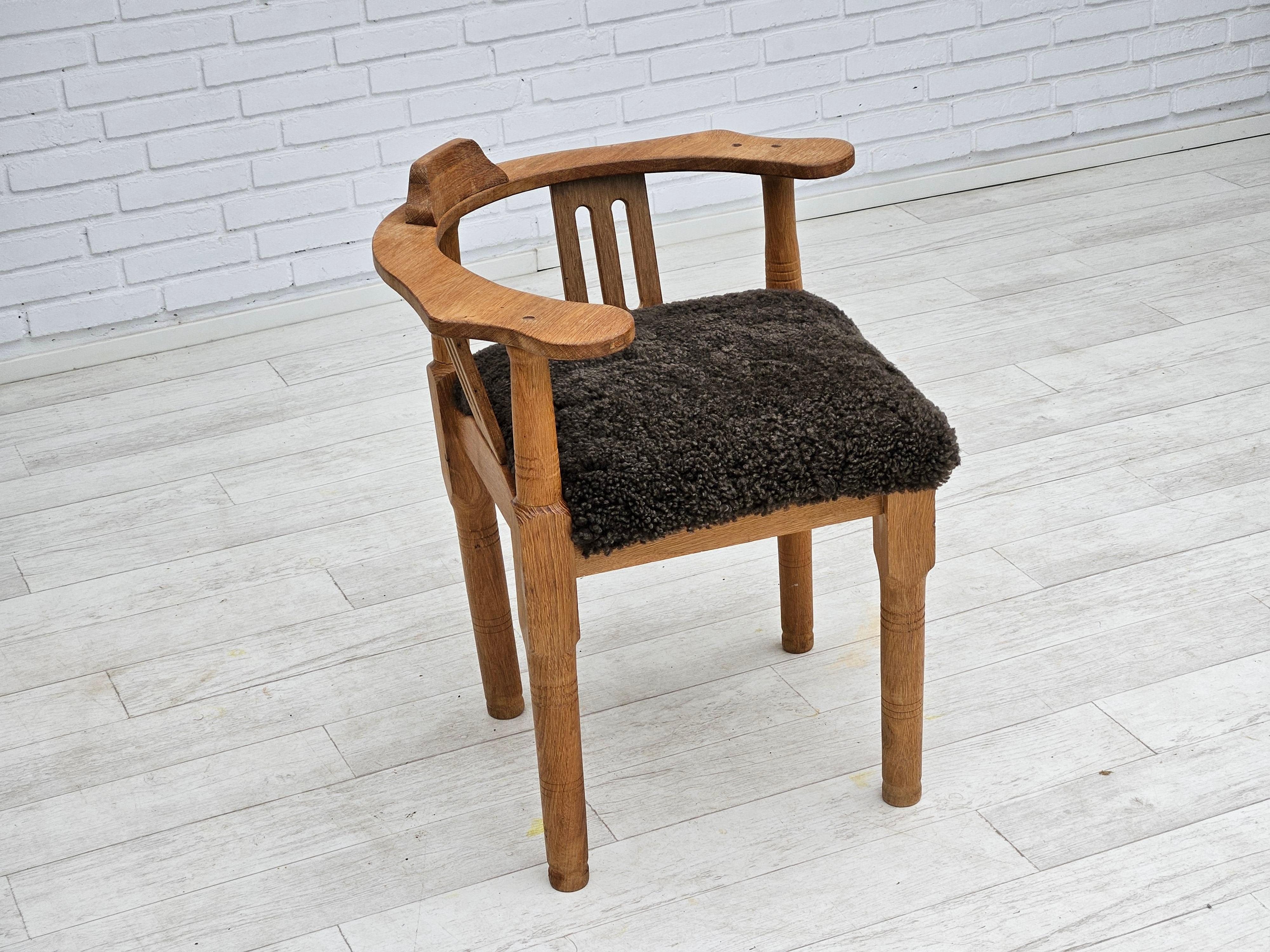 1950s, Danish design. Reupholstered armchair in quality New Zealand sheepskin Wellington. Renewed oak wood. Manufactured by Danish furniture manufacturer in about 1955s. Reupholstered by craftsman.