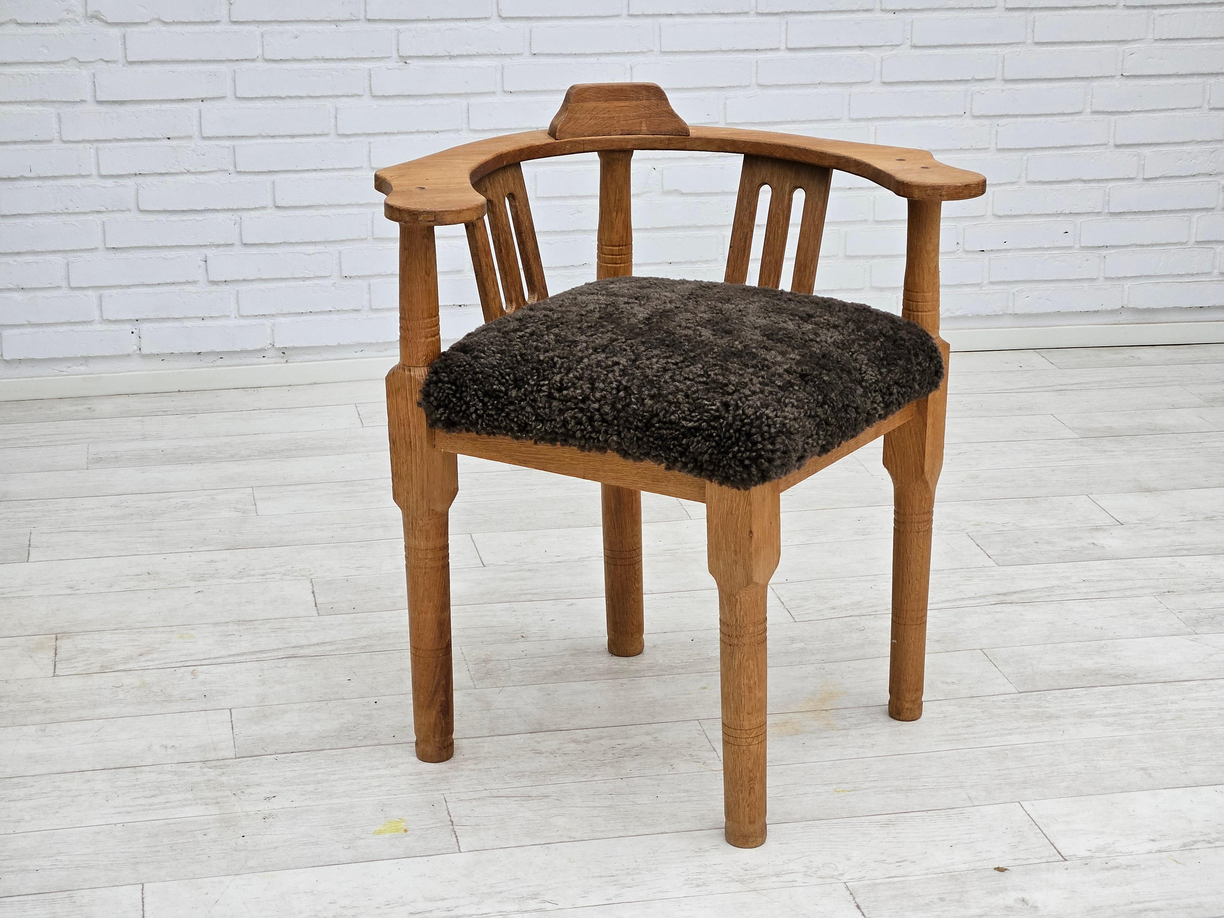 Scandinavian Modern 1950s, Danish design, reupholstered armchair, New Zealand sheepskin, oak wood. For Sale