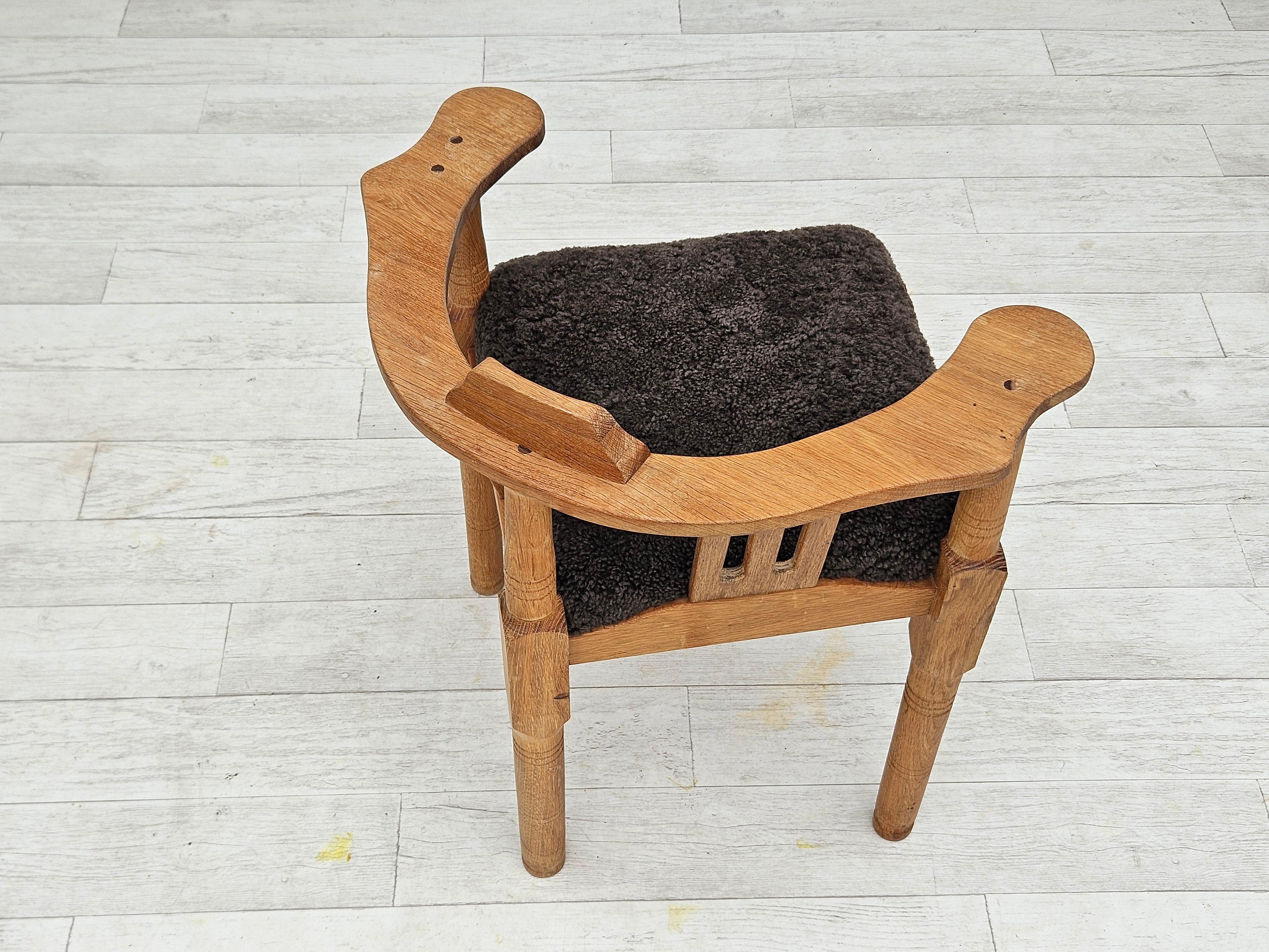 Mid-20th Century 1950s, Danish design, reupholstered armchair, New Zealand sheepskin, oak wood. For Sale
