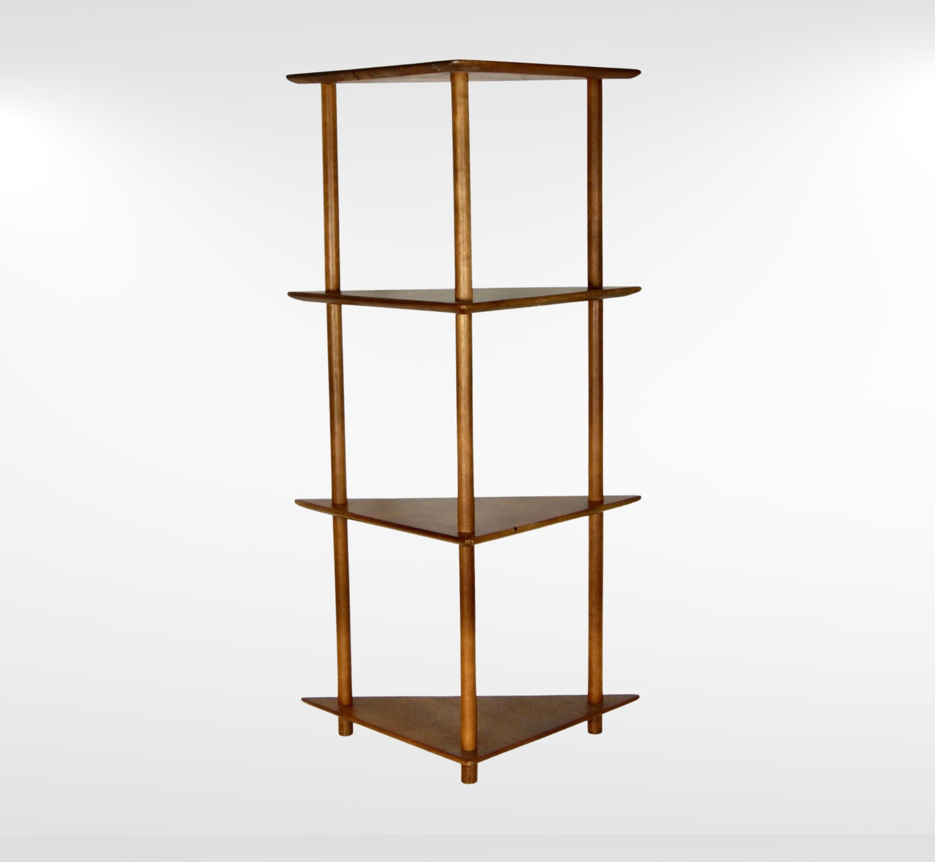 Unique mid-century Scandinavian teak angled corner bookshelf.
Streamline minimalist design furniture.
Designed to fit into angled corners and reading nooks.
Made of solid teak shelves and legs.
The shelves have delicately rounded yet angled and