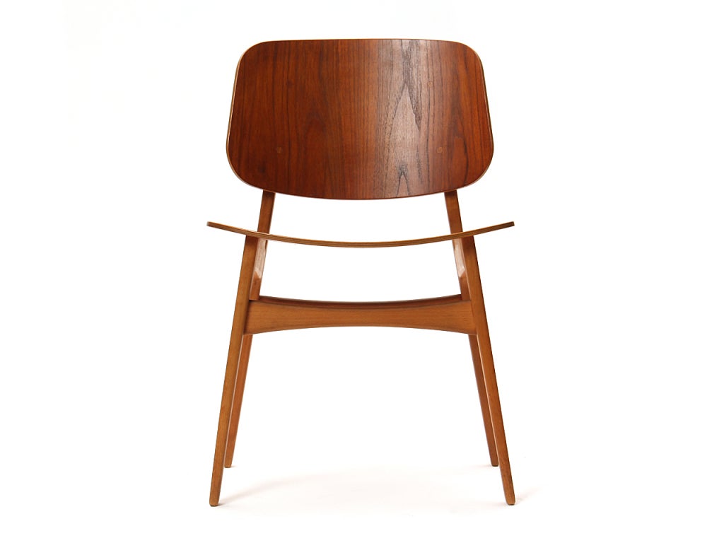 A side chair with a solid beech frame and a seat and back of molded teak plywood. Most bear makers mark.