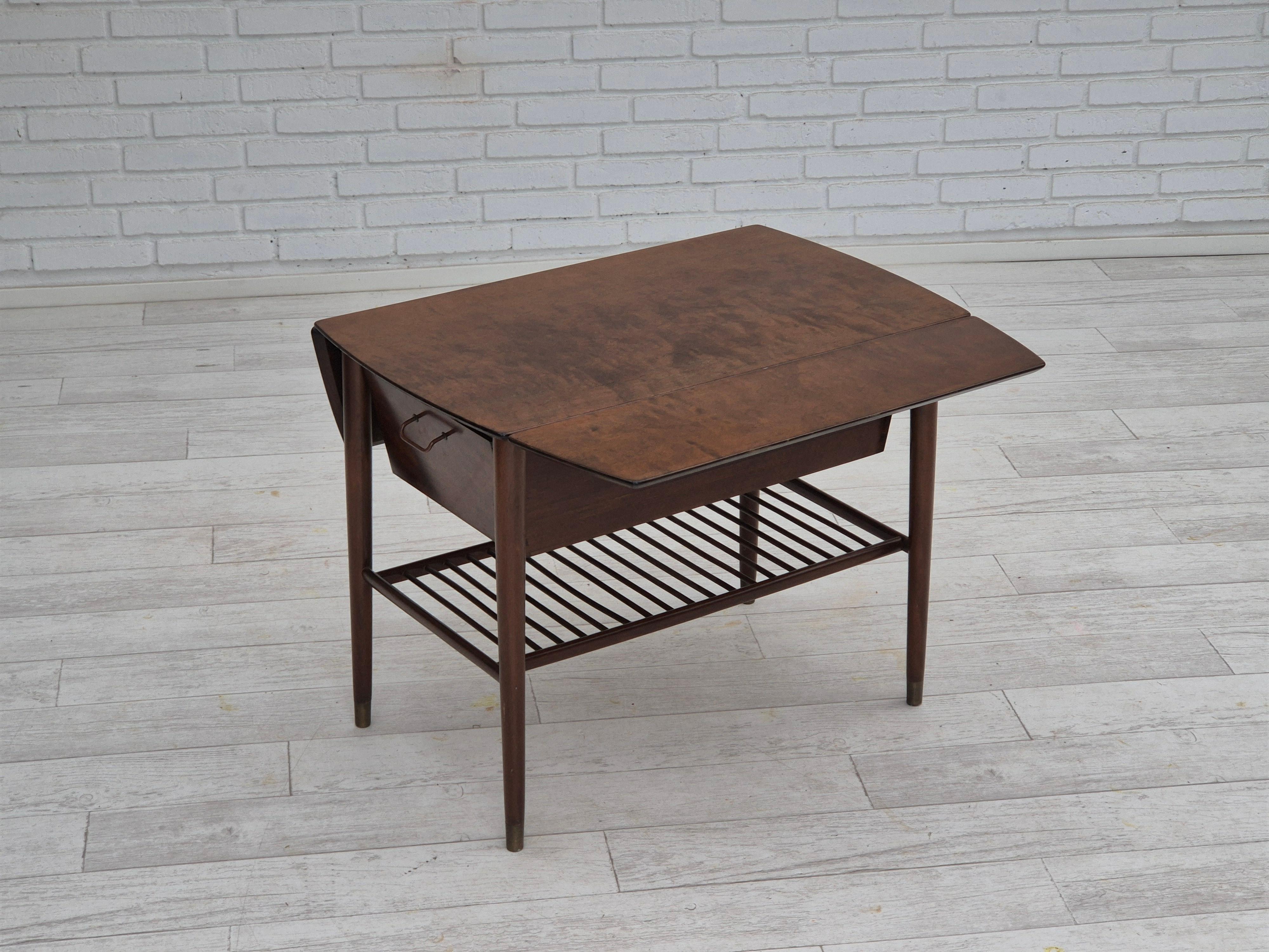 1950s, Danish foldable coffee table with drawer and shelf. Original good condition. Beech wood legs with brass plugs. Top of beech wood, drawer in plywood with brass handlebars. Manufactured by Danish or Swedish furniture maker in about 1950-55s.