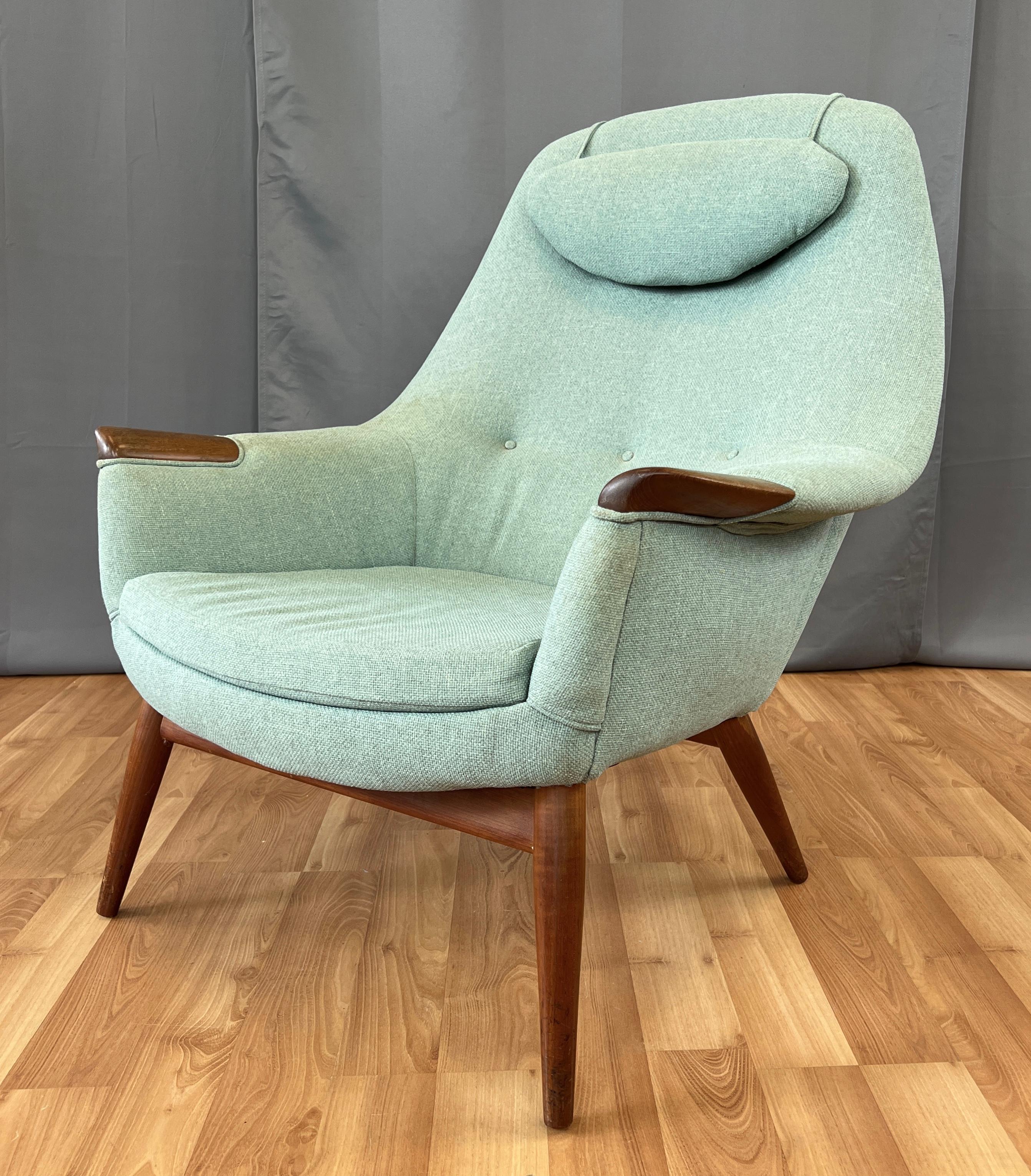 Offered here is a circa 1950s Danish lounge chair with a high curved back, and at it's arms ends Teak paws.
A weighted head rest hangs from it's back rest. Chair has great bones, just waiting to be refinished and recovered to match
your decor.