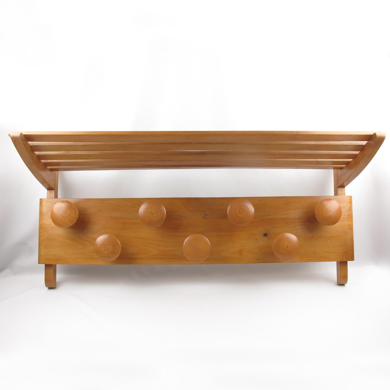 Oversized Mid-Century Modern wall-mounted wood coat rack with hat storage. Lovely varnish maple wood with Scandinavian / Danish design style. Seven round coat hooks and extra-large storage tray. No visible maker's mark.
Measurements: 36.44 in. wide