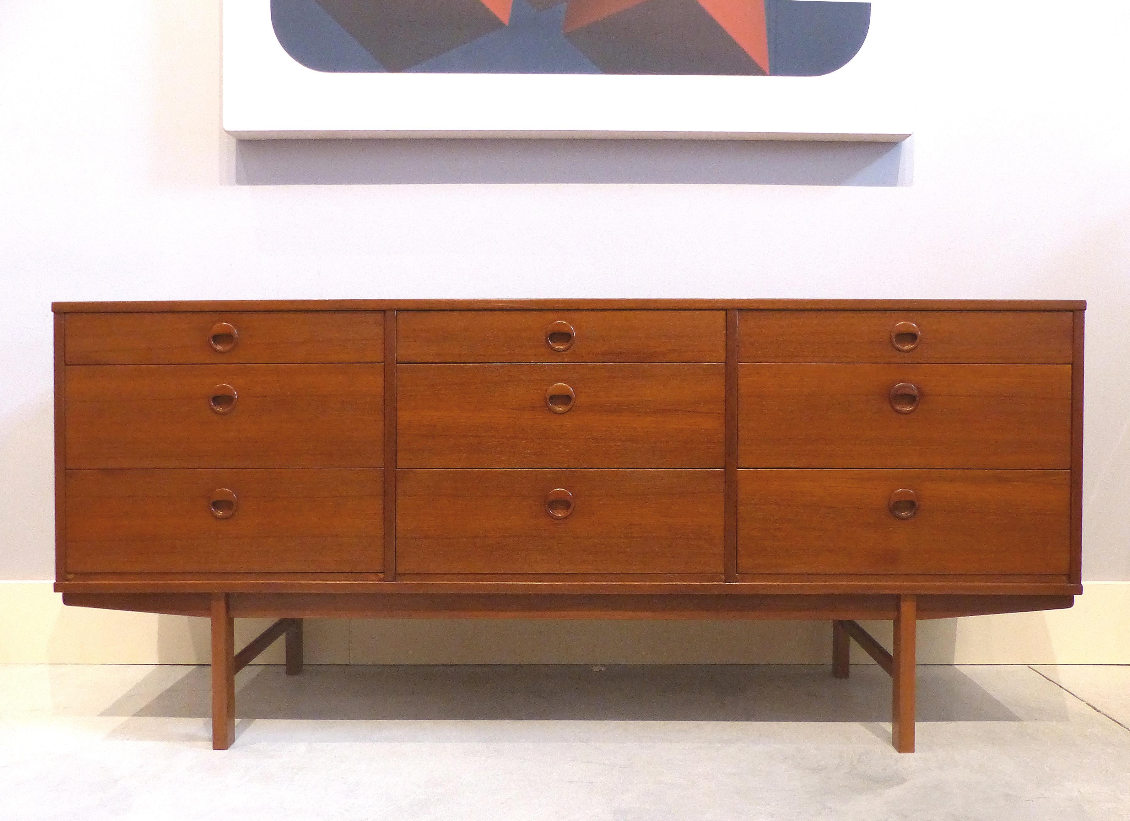 Offered for sale is a teak Danish Modern dresser by Folke Ohlsson for DUX. This 1950s cabinet has recently been refinished. The 9-drawer dresser offers three sets of matching drawers with the top centre drawer having divided compartments.

    