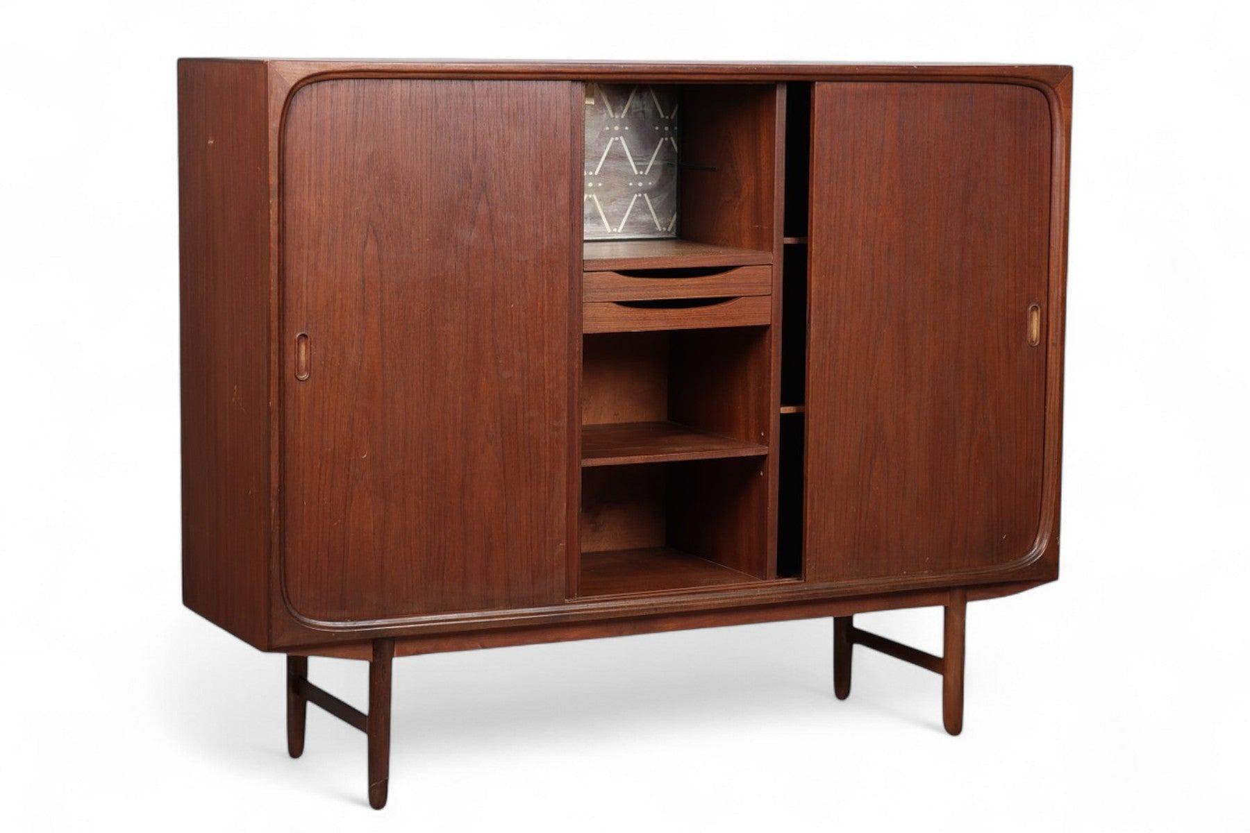 Origin: Denmark
Designer: Unknown
Manufacturer: Unknown
Era: 1960s
Materials: Teak
Measurements: 59″ wide x 17.25″ deep x 47.75″ tall