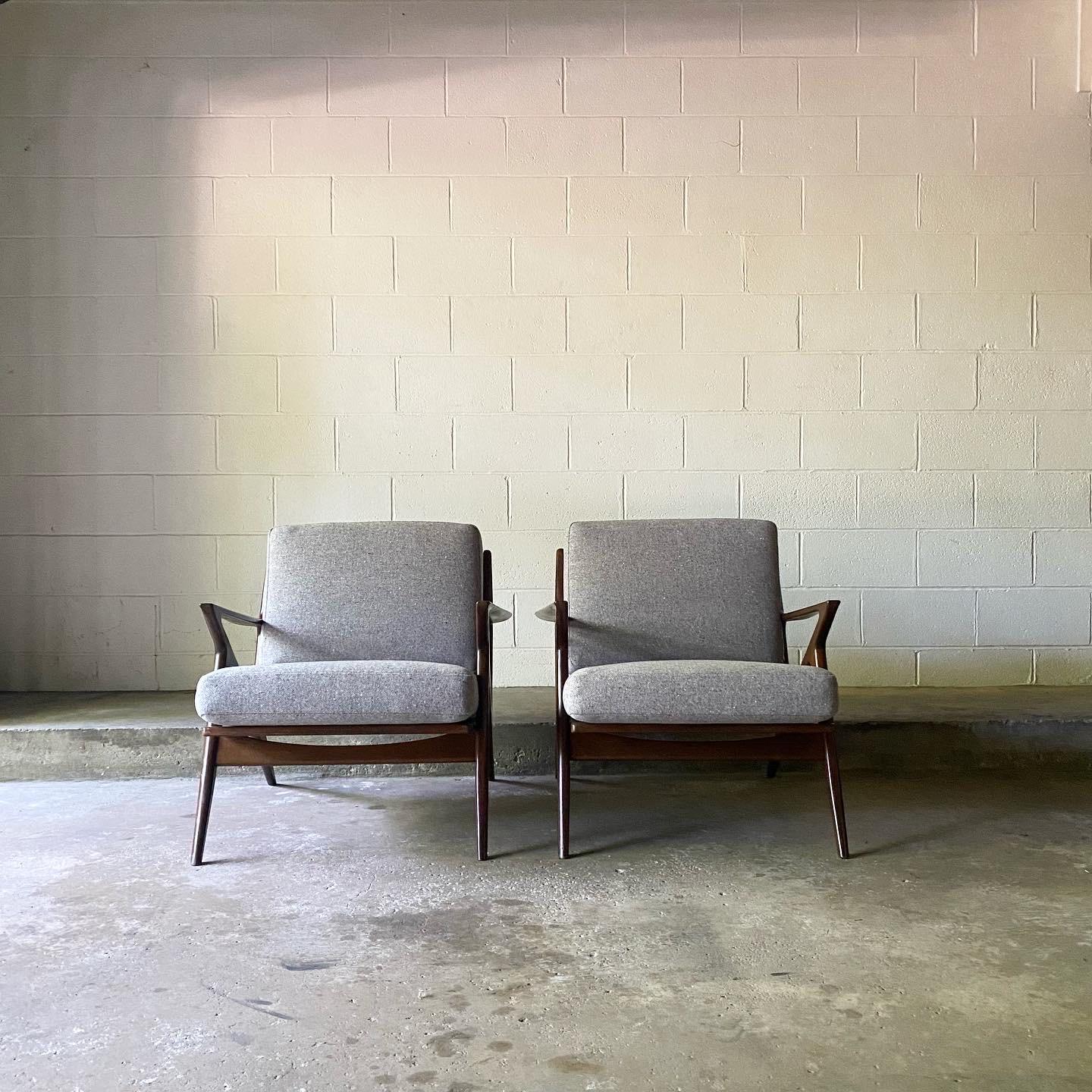 This is an exceptional all original pair of “Z” chairs designed by Poul Jensen for Selig, ca. 1950’s Denmark. The frames are constructed of solid beech wood, finished in a walnut lacquer. The cushions are brand new, professionally upholstered in a