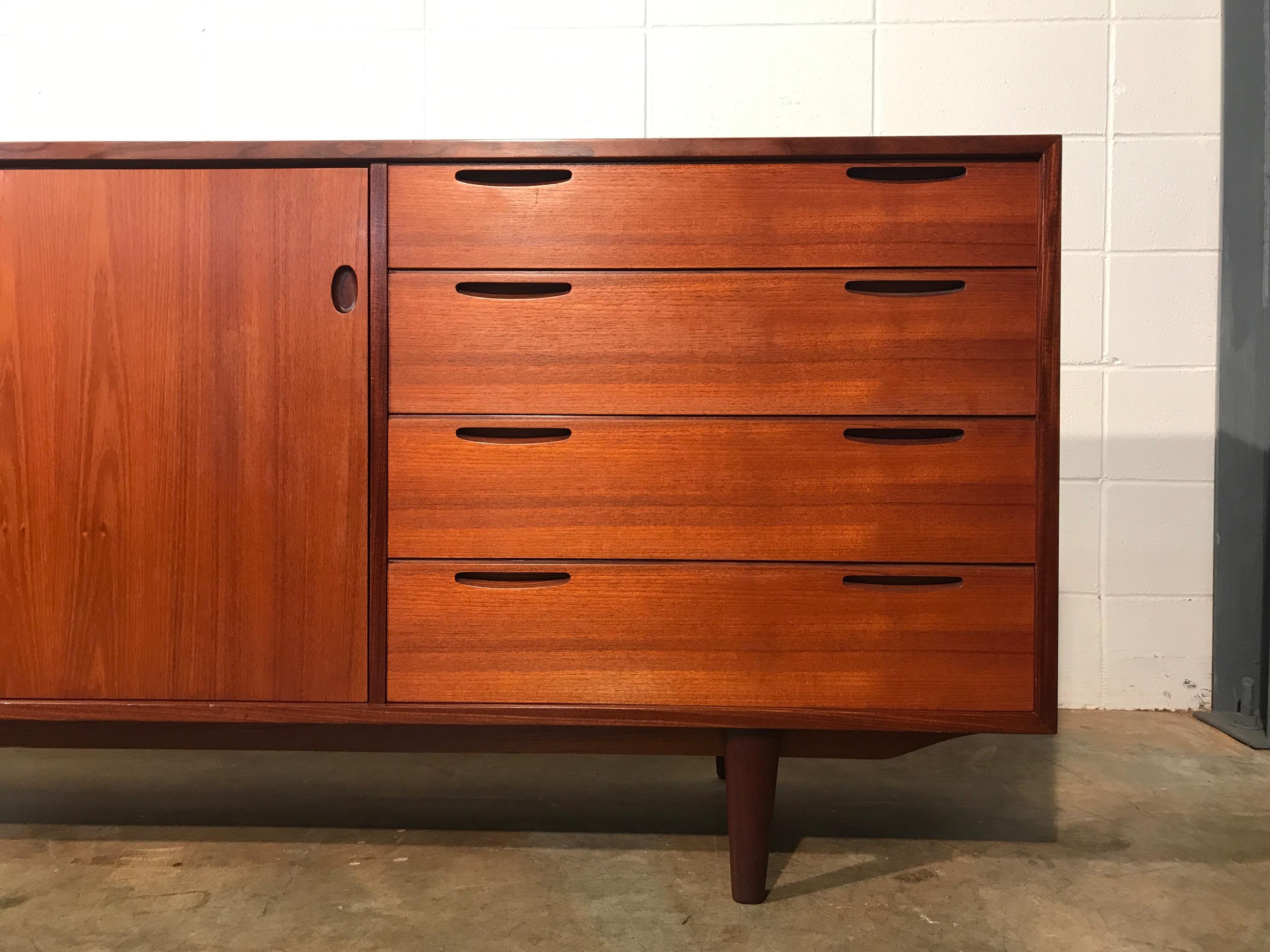 1950s Danish Modern Teak Credenza By IB Kofod Larsen For Brande Mobelfabrik.
Quality construction in this 1950s credenza. Over 6.5 FT long teak credenza with a total of six drawers plus shelving for plenty of room for storage. This piece is