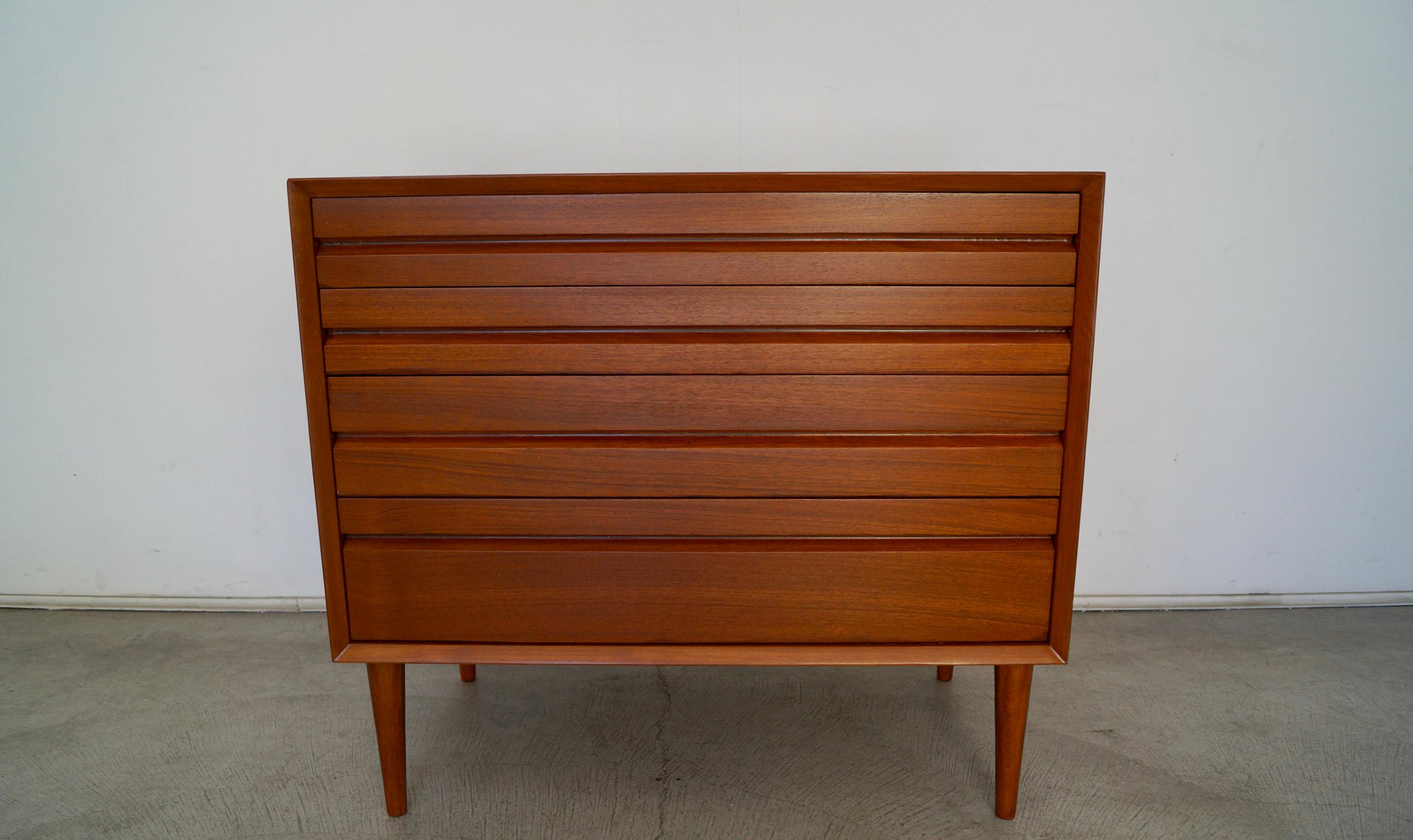 Vintage Mid-century Modern dresser for sale. Original Danish Modern design piece, and made of teak. It has been professionally refinished, and has four drawers. It has the clean Scandinavian design and is really solidly built. It was manufactured in