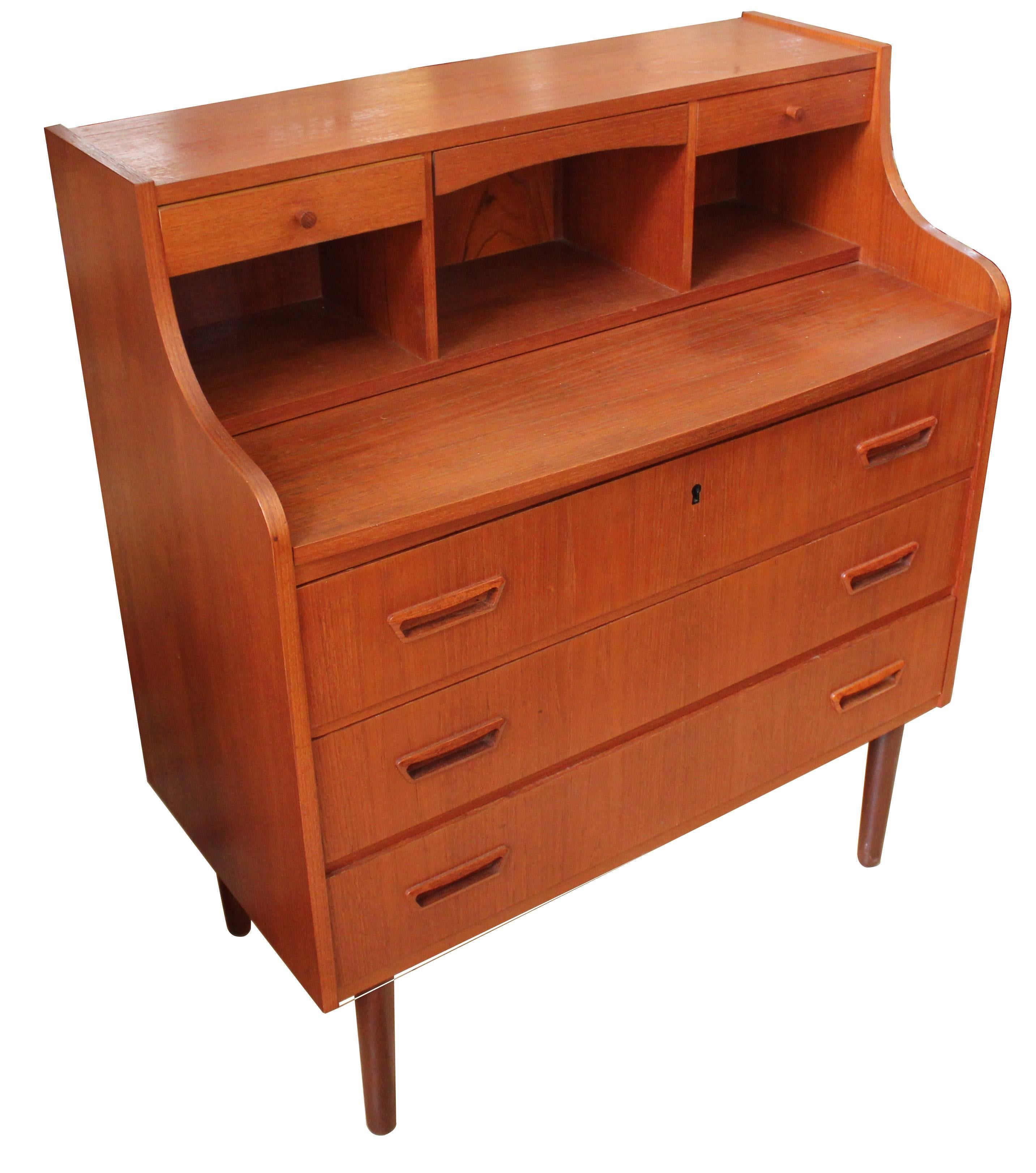 1950s Danish modern teak secretary desk with fold-down mirror and extendable desk top. The desk has three lower drawers and two small organizing drawers in the upper portion. At full extension, the desk top provides 16