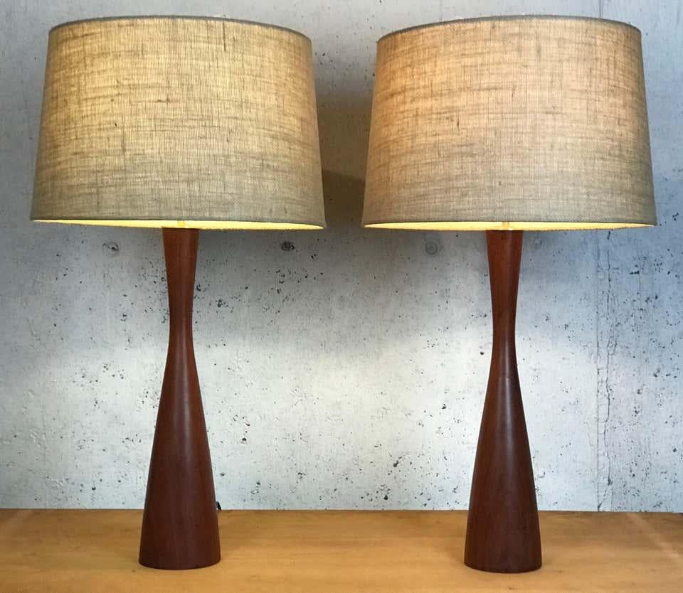 Gorgeous pair of early 1950s Danish modern teak hourglass lamps in the manner of Phillip Lloyd Powell. The teak has aged to a nice darkened color. New brass hardware. Rewired.
There are several minor blemishes - please see pictures.
Shades not