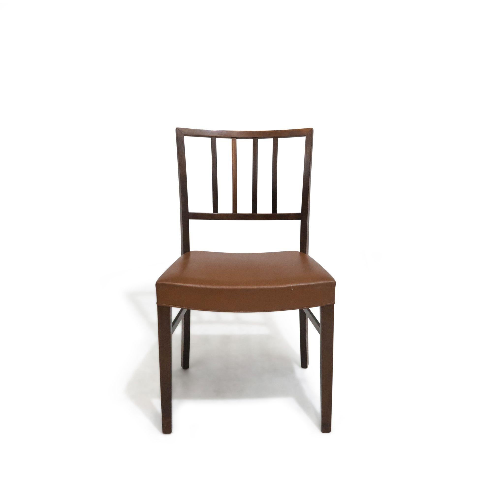Set of 6 dining chairs in manner of Jacob Kjaer, crafted of rosewood with minimal slatted backs, upholstered in the original saddle leather.
The chairs are in good original condition.
 
Measurements:
18.75'' x D 20.25'' X H 32.50''
Seat Height