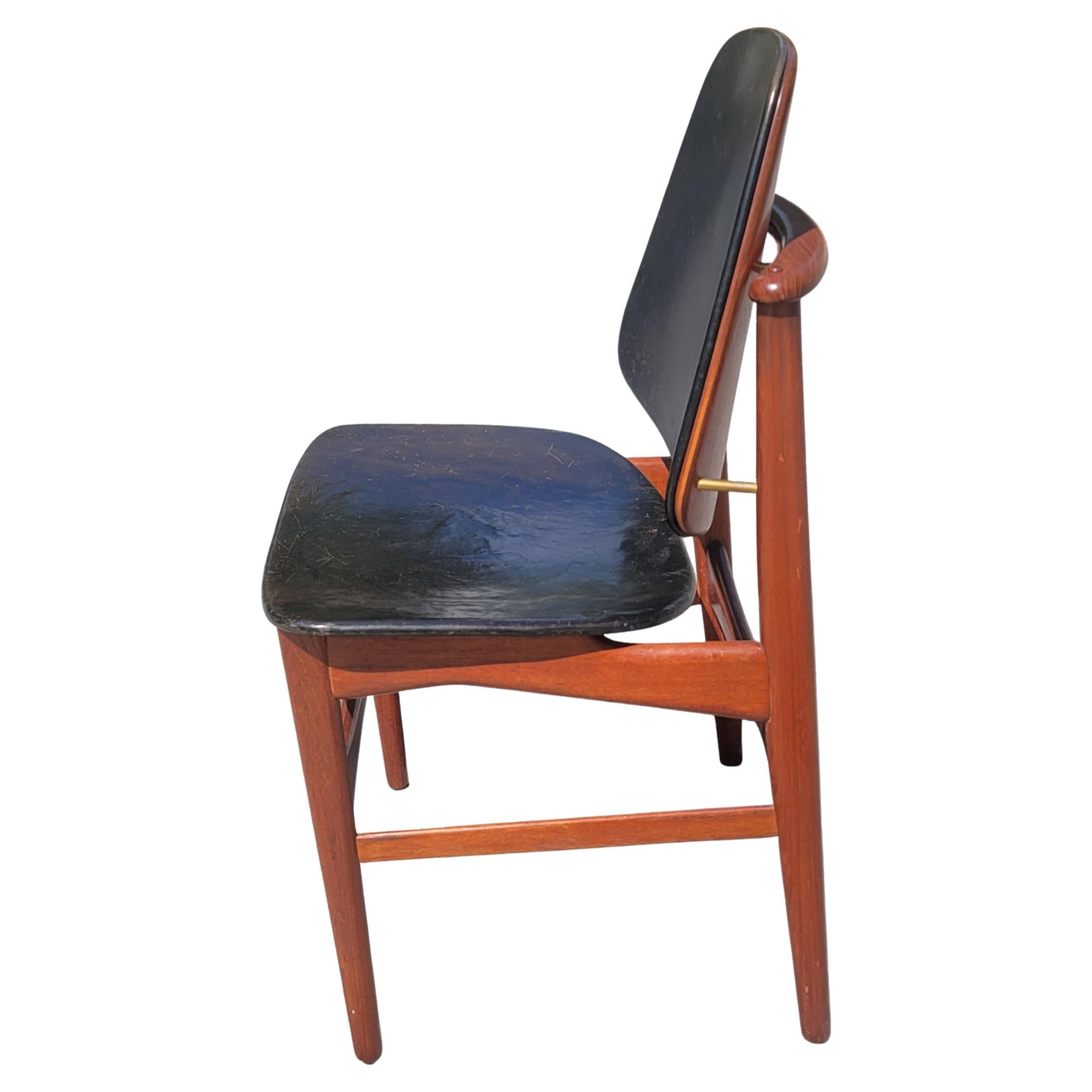 A 1950s Danish modern chair in Solid Teak chair designed by Arne Vodder for France & Daverkosen. Great condition with nice patina on black leather back and seat, as well as on solid teak wood frame. Measures 19.5
