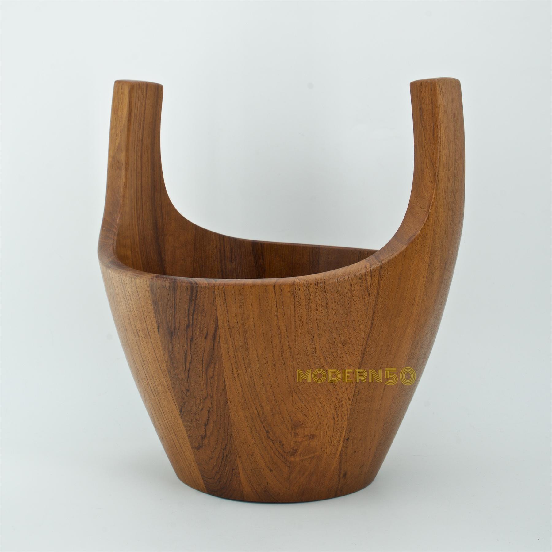 Denmark, circa 1950s. Staved teak bowl designed by Jens Quistgaard for Dansk. A midcentury re-interpretation of the traditional wooden Quaich. Measures: 10 5/8 inches high, 10 inches wide, 9 1/2 inches deep. Branded mark on underside, three duck