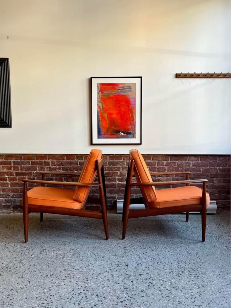 Step into mid-century sophistication with this exquisite pair of 1950s model FD-118 armchairs by Grete Jalk for France and Daverkosen. As the earliest edition of this iconic design, these chairs exude timeless elegance. Crafted with solid teak and