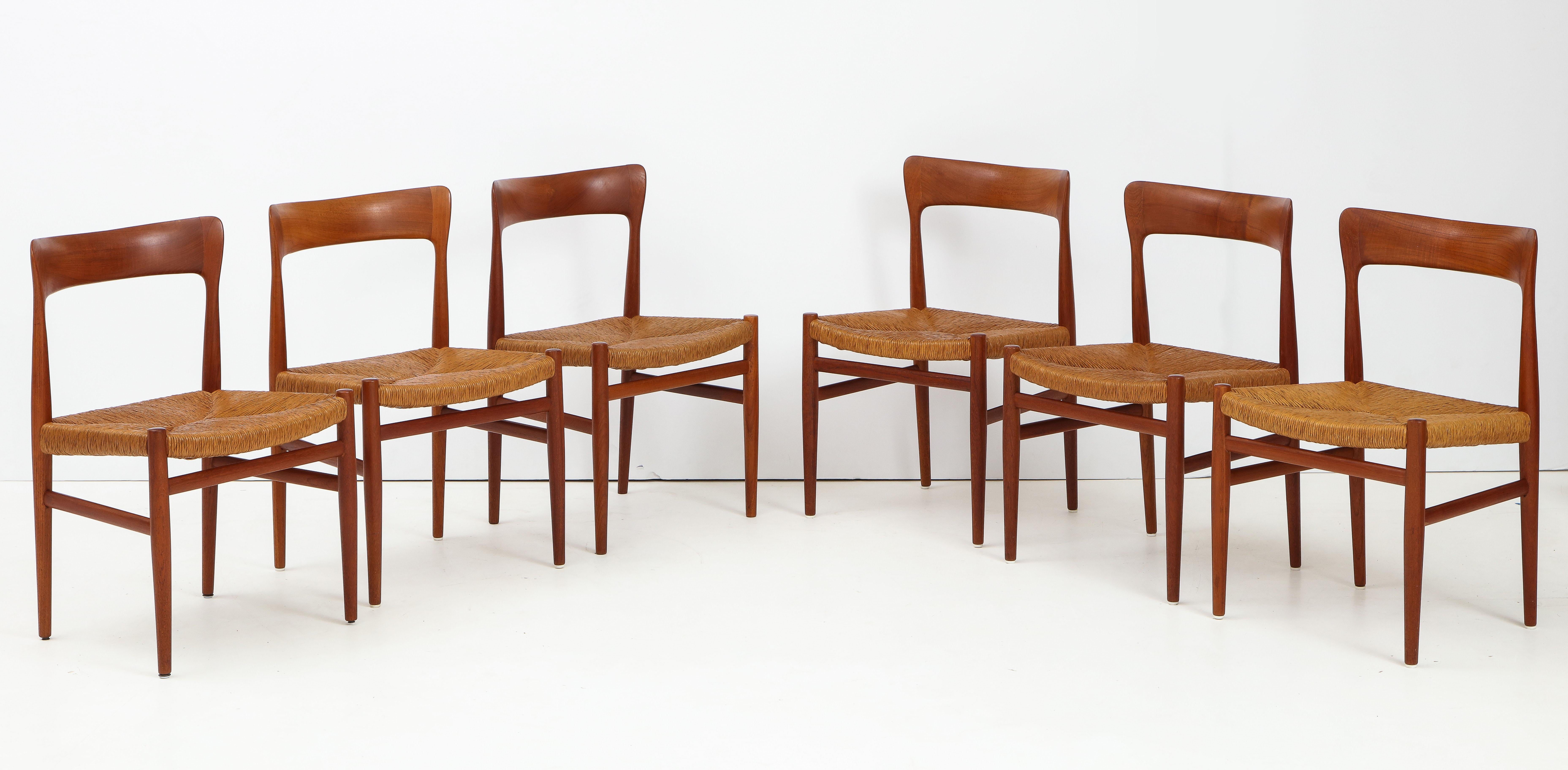 Stunning set of six Danish teak sculptural dining chairs. With vintage original paper cord seats.