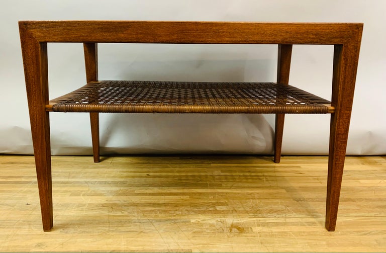 A beautifully made with interesting joint detail. A classic design side or coffee table with an underlying shelf made from woven cane which is still very much in tact. Designed by Severin Hansen and manufactured by Haslev Furniture during the