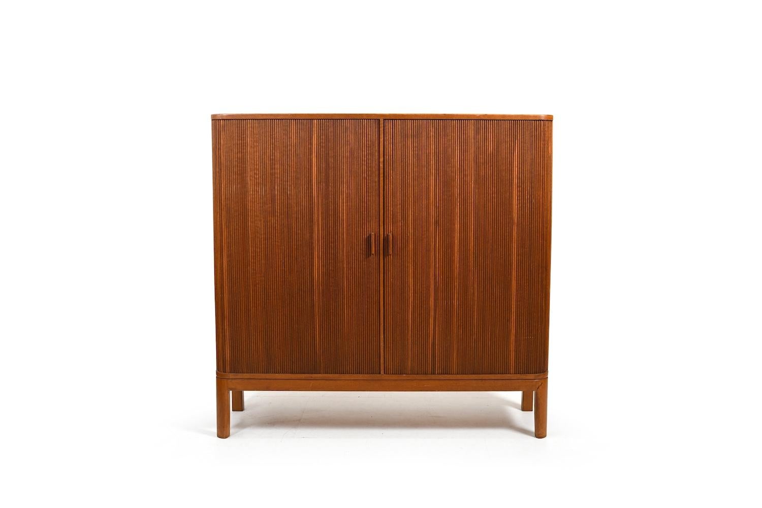Danish tambour doors teak cabinet with birch drawers and shelfes inside. (3 shelves included, forgot to use when taking photos ). In very good quality and condition. Denmark 1950s.