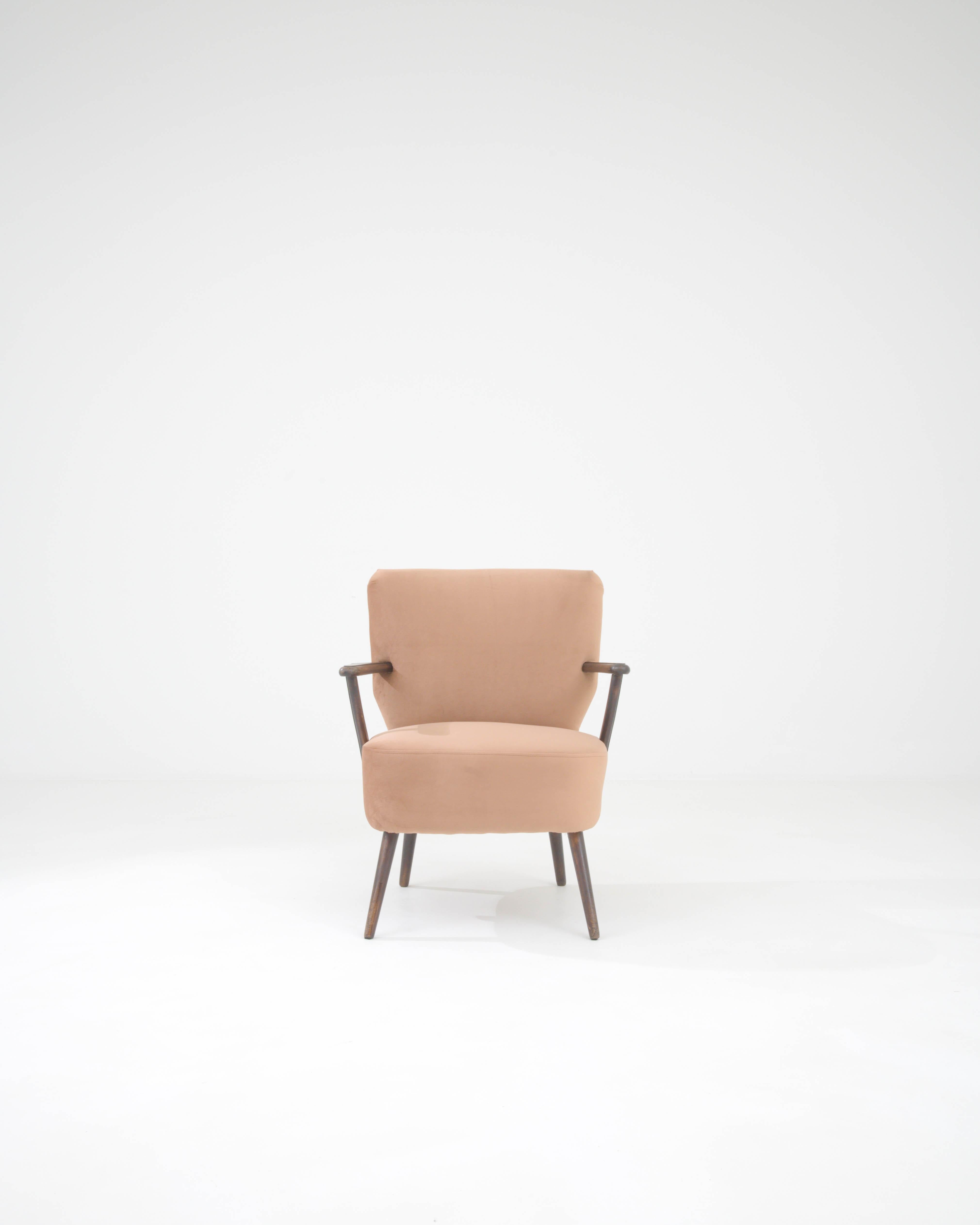 Introducing the quintessence of mid-century charm — our 1950s Danish Upholstered Armchair. This piece captures the spirit of Danish design with its minimalist aesthetic and functional form. It's an invitation to timeless elegance with its sleek