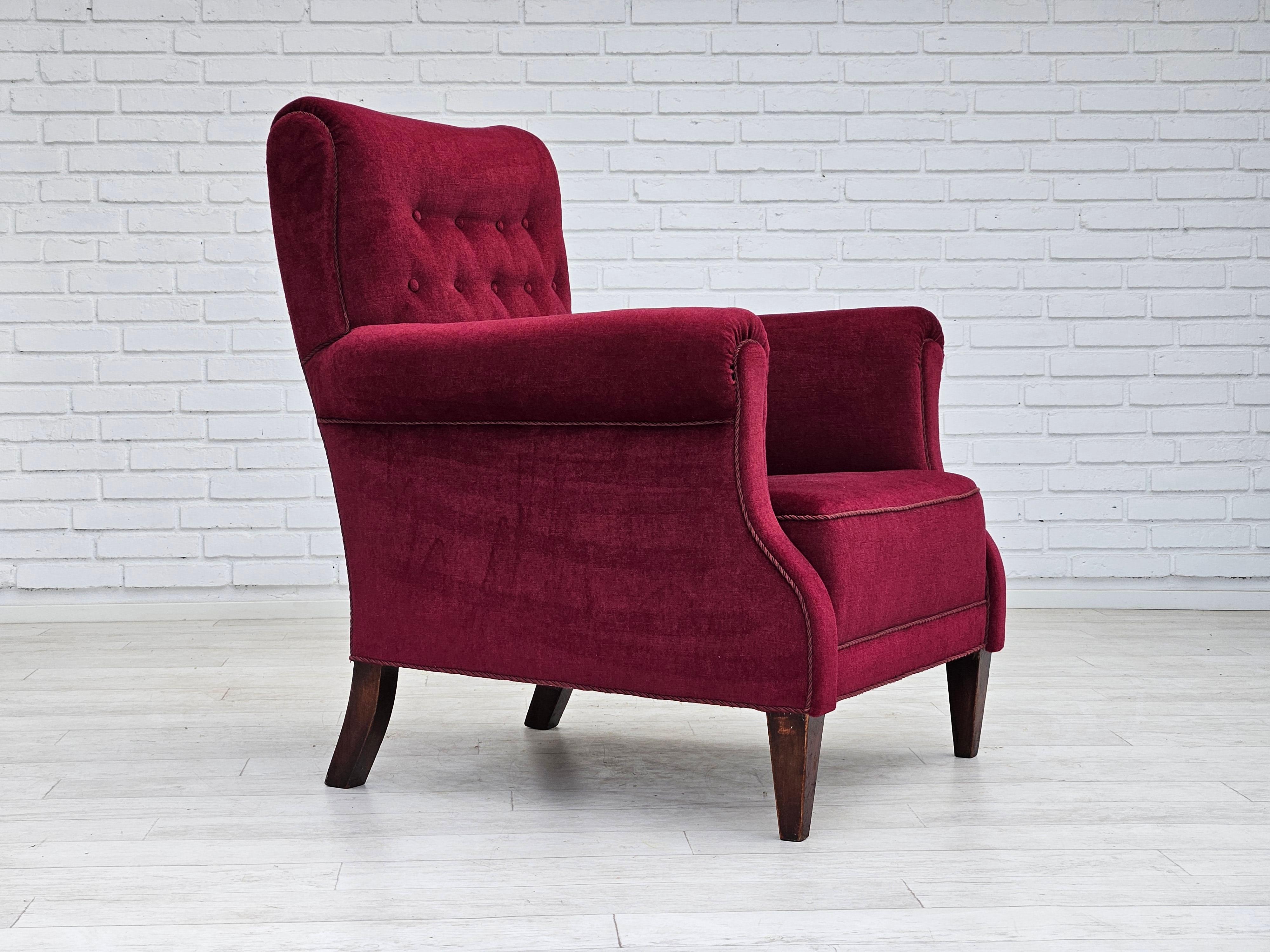 1950s, Danish design. Armchair in cherry-red velour. Original very good condition: no smells and no stains. Ash wood legs. Original springs in the seat. Manufactured by a Danish furniture manufacturer in about 1950-55.