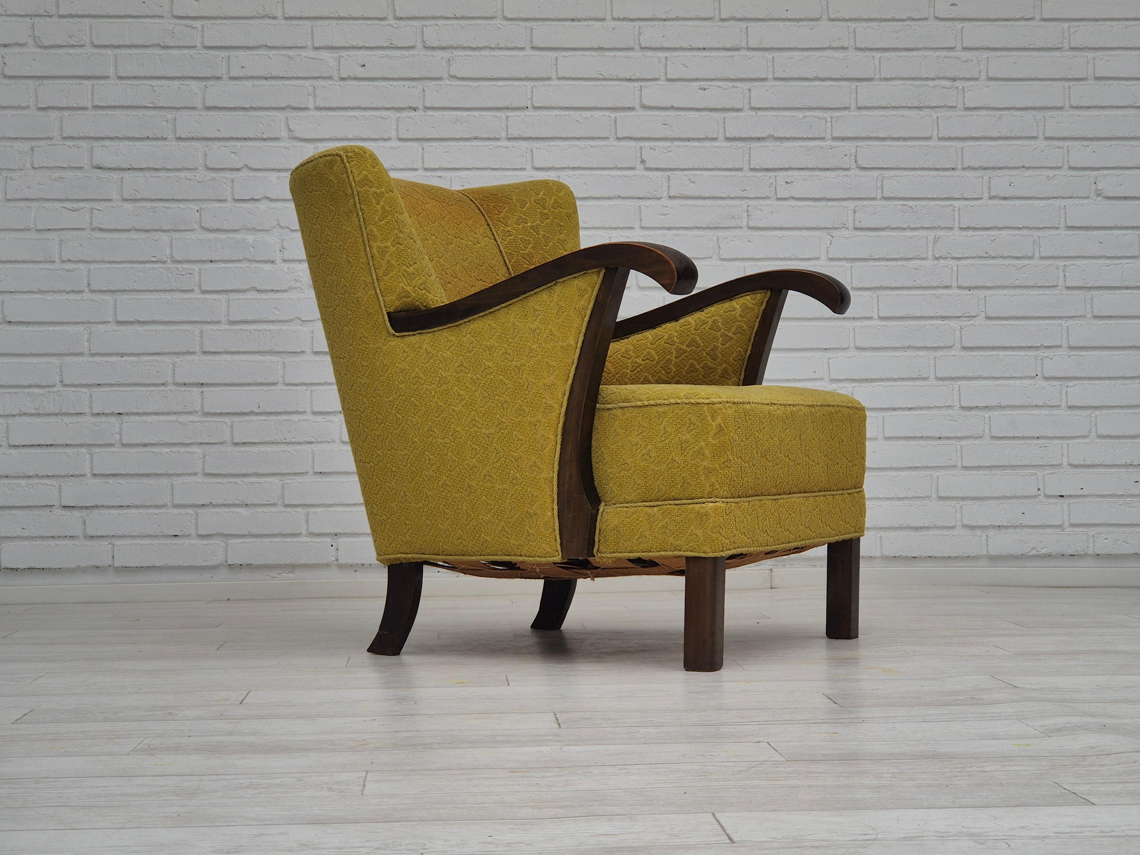 1950s, Danish handcrafted armchair. Original good condition: no smells and no stains. Light green furniture wool fabric, beech wood legs and armrests. Brass springs in the seat. Handcrafted by Danish furniture manufacturer in about 1950-55s.