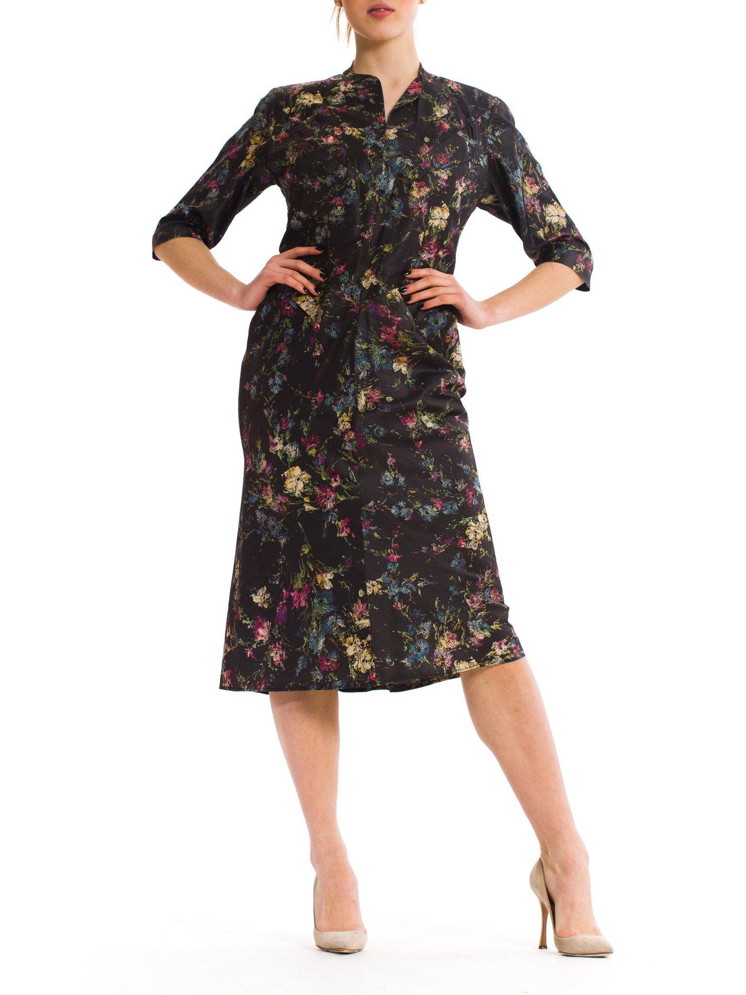 Genius pattern design to this fully lined dress. The skirt is cut on the bias with no side seams. Diagonally cut at the waistline which extends into a belt for cinching the waist in the back, all in one piece! Lined in rayon.  1950S Dark Grey Floral