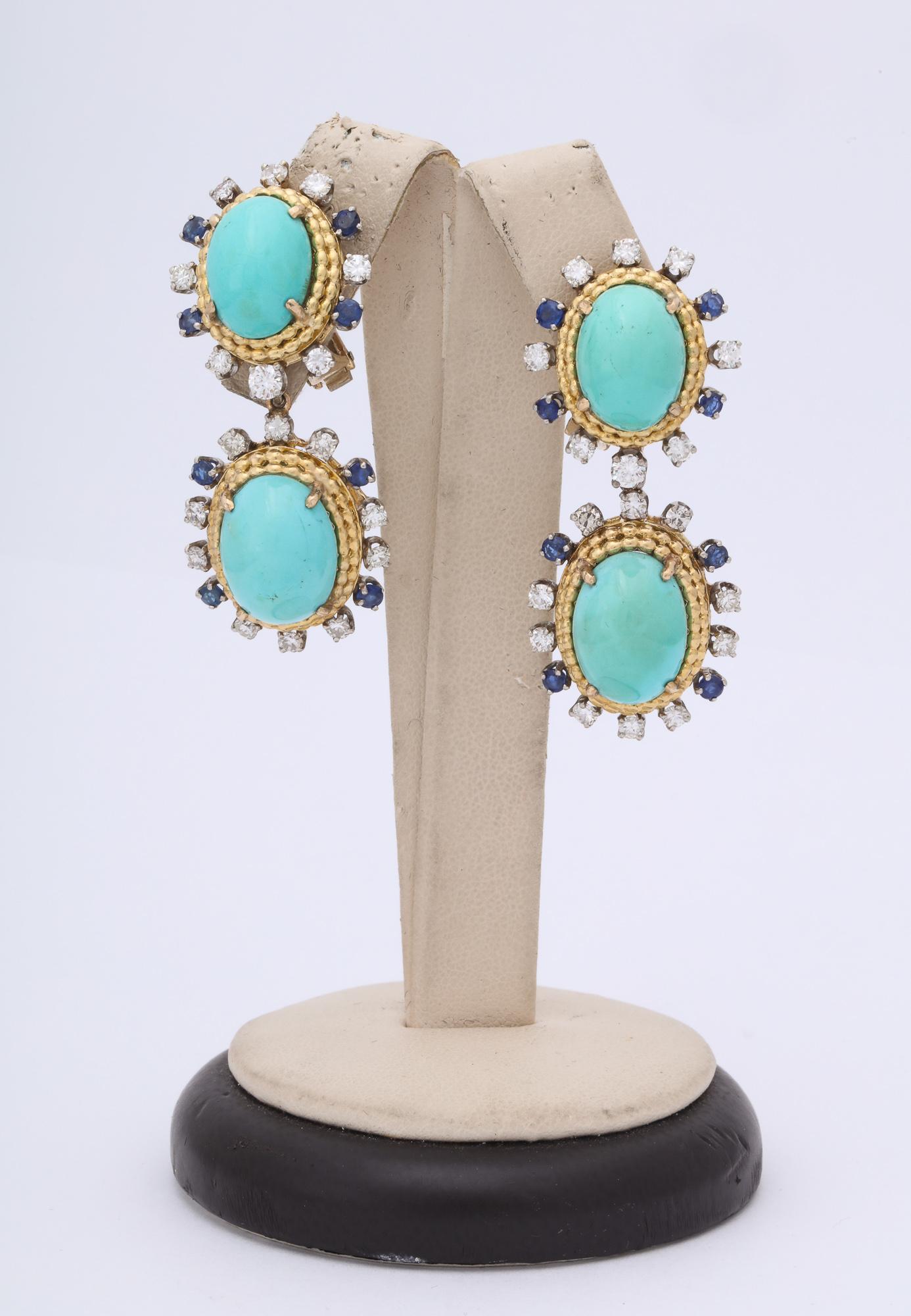 One Pair Of 18kt Yellow Gold Earclips With Fancy Clip On Backs Embellished With Four Oval Shaped Cabochon Cut Turquoise Stones Ranging In Size From 12Mm To 15MM . Earrings Are Further Designed With Thirty Six Full Cut Brilliant Cut Diamonds Weighing