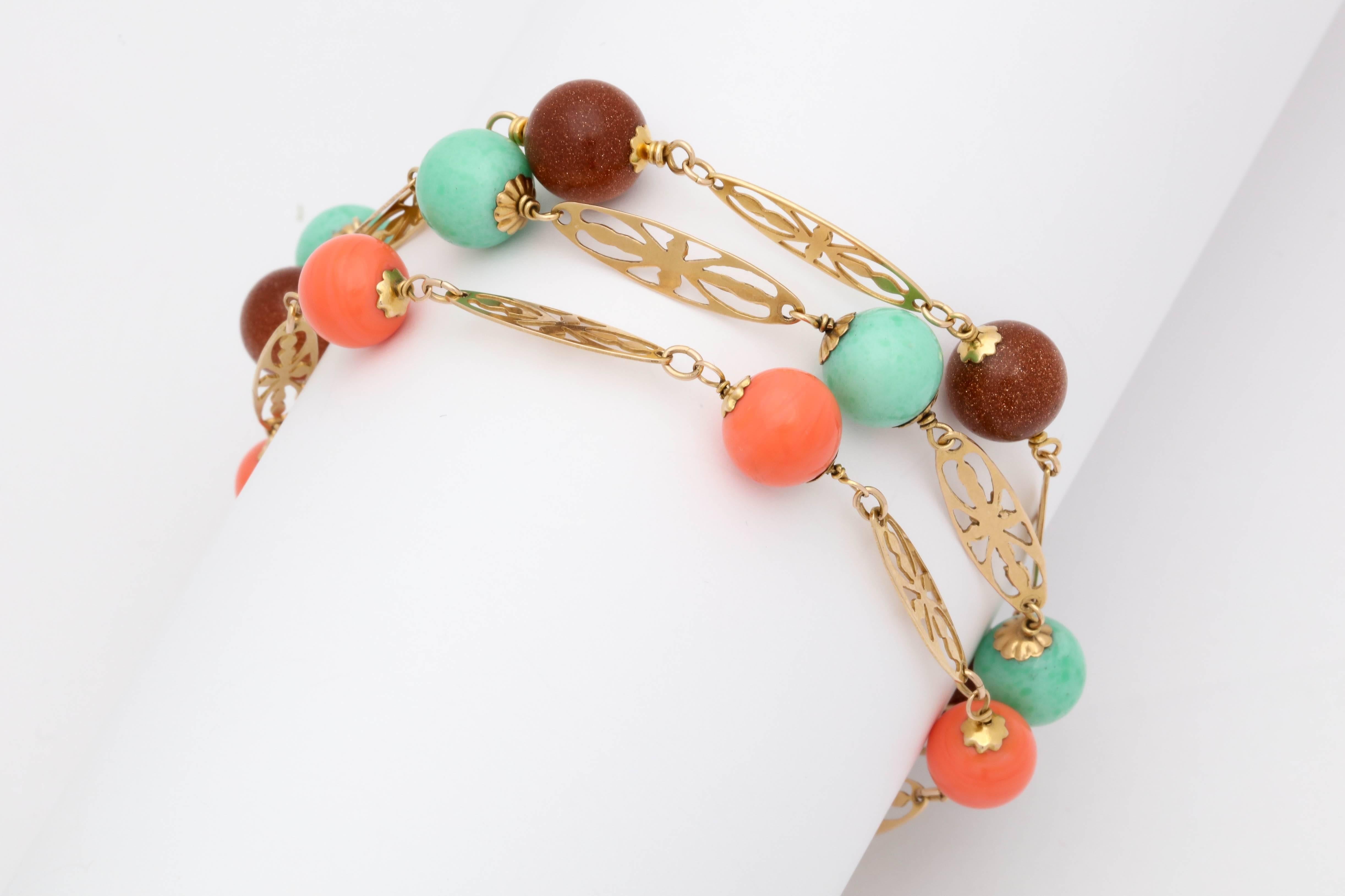 A Triple Pair Of 14kt Reticulated Cut Out Flower Gold Bracelets Each Designed With Three Different Semi Precious Stones Consisting Of Five Coral Bead Stones And With Six Turquoise Bead Stones And Finally with Five Gold Stone Beads.Very Nicely Worn