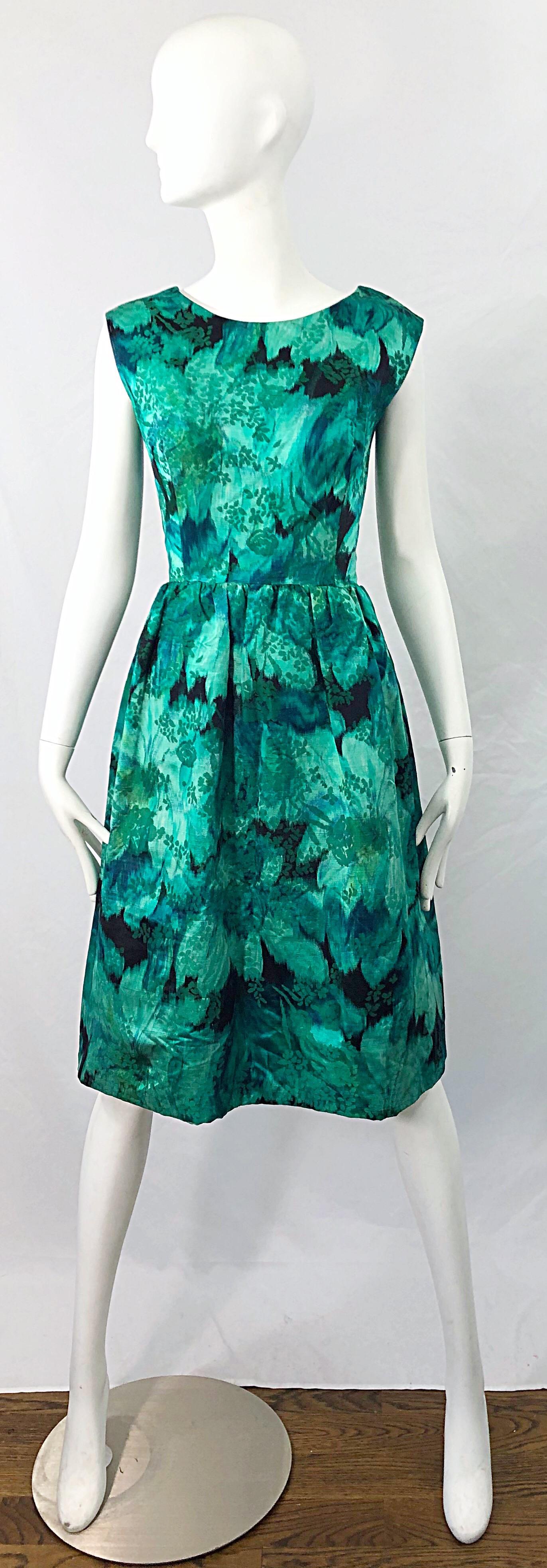 Beautiful 1950s demi couture green botanical floral print silk fit n' flare sleeveless dress ! Features various shade of green throughout. Hidden metal zipper up the back with hook-and-eye closure. Can easily be worn for any day or evening event.