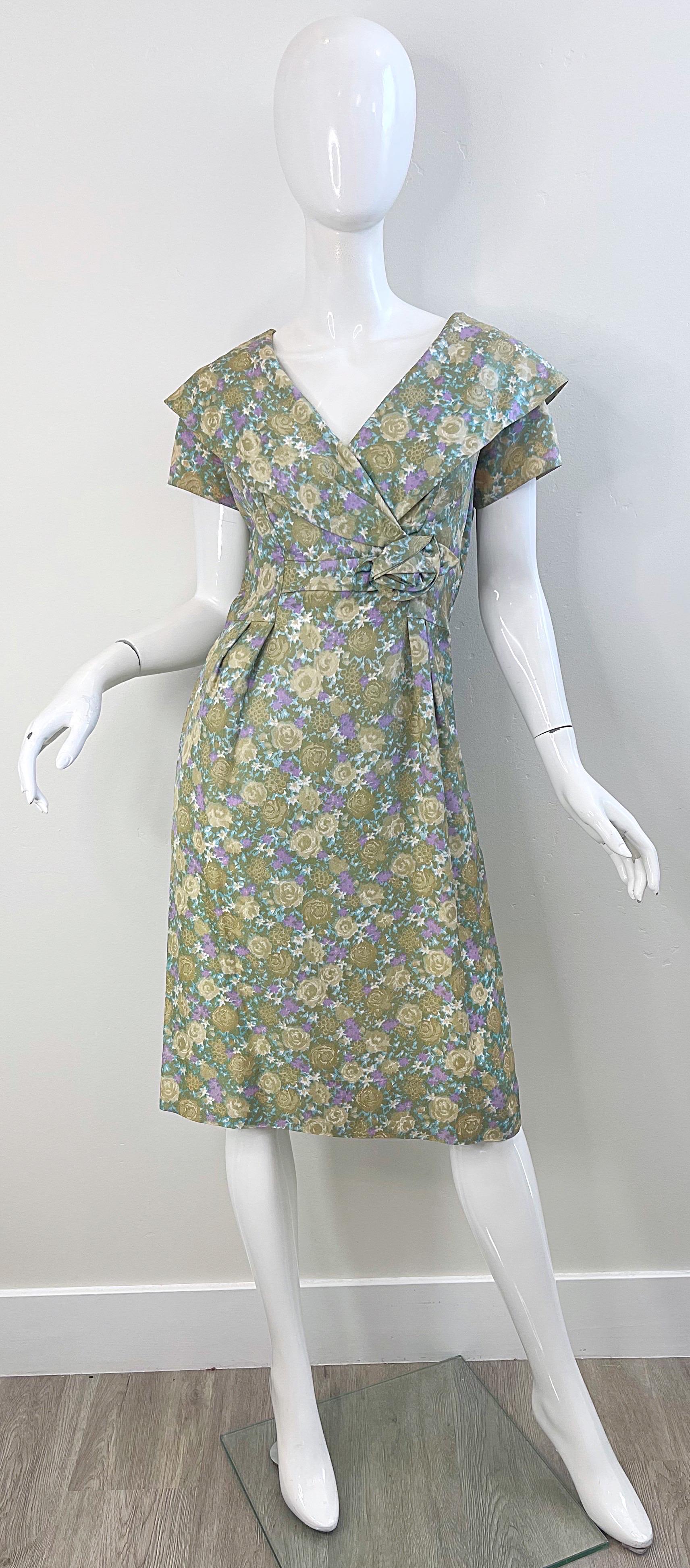Beautiful 1950s demi couture shawl collar short sleeve silk dress ! Features floral prints in different shades of green, tan and purple Hidden metal zipper up the back. Tailored bodice with a forgiving skirt. Extremely well made with so much