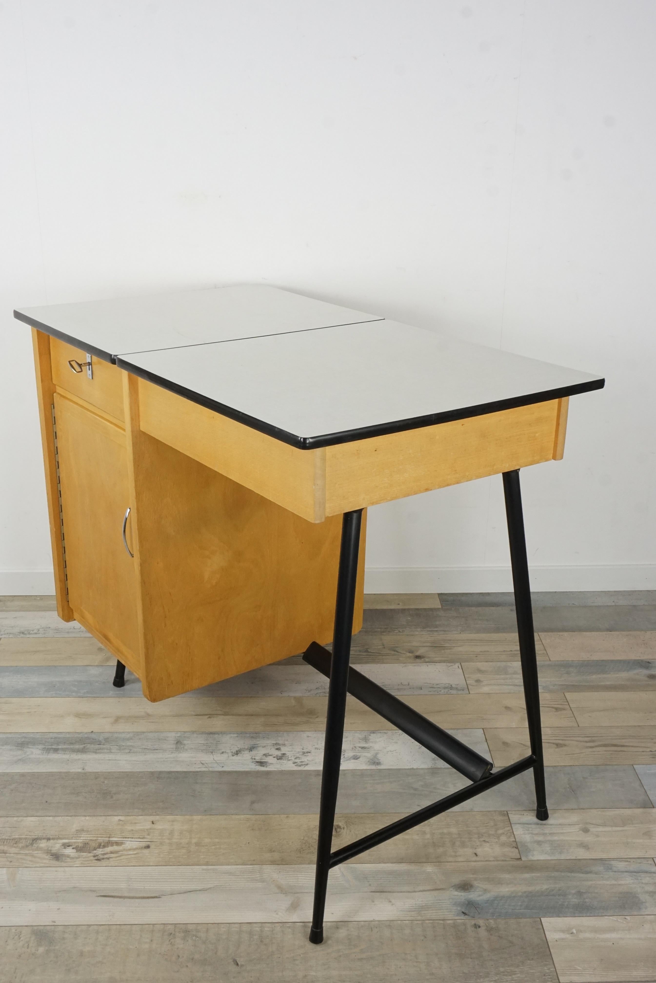1950s design little desk is composed of black metal compass feet, wooden structure and formica sectional tray.