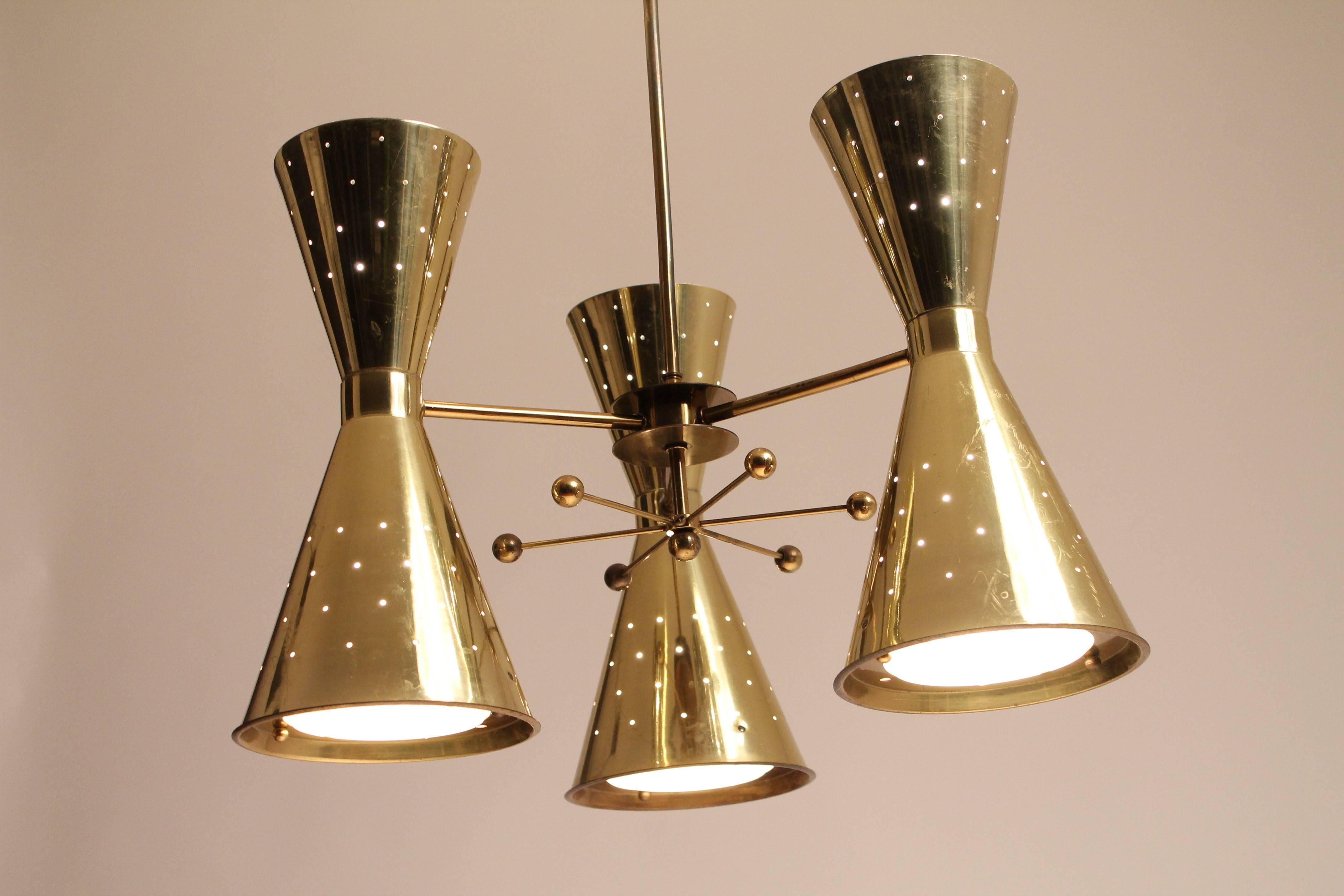 Each pierced brass-plated shade is 14 inches high by 7 inches diameter for the lower portion. All remaining hardware is made of brass.

Under each shade, there is glass lens (Fresnel) made to disperse light evenly. A brass outer ring held by two