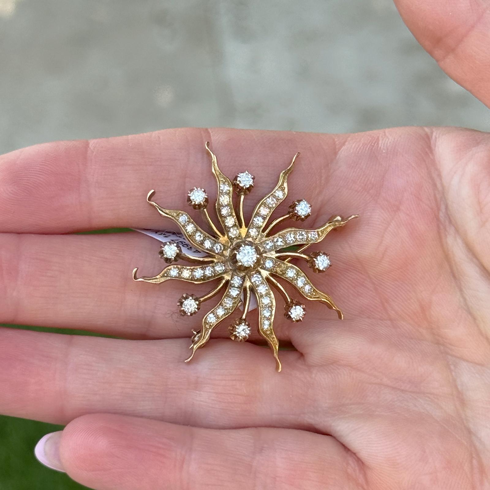 This vintage starburst pin is beautifully crafted in 14K yellow gold and showcases a dazzling array of round-cut diamonds arranged in a radiant, mid-century-inspired starburst design. With approximately 1.25 carats total weight of diamonds, the