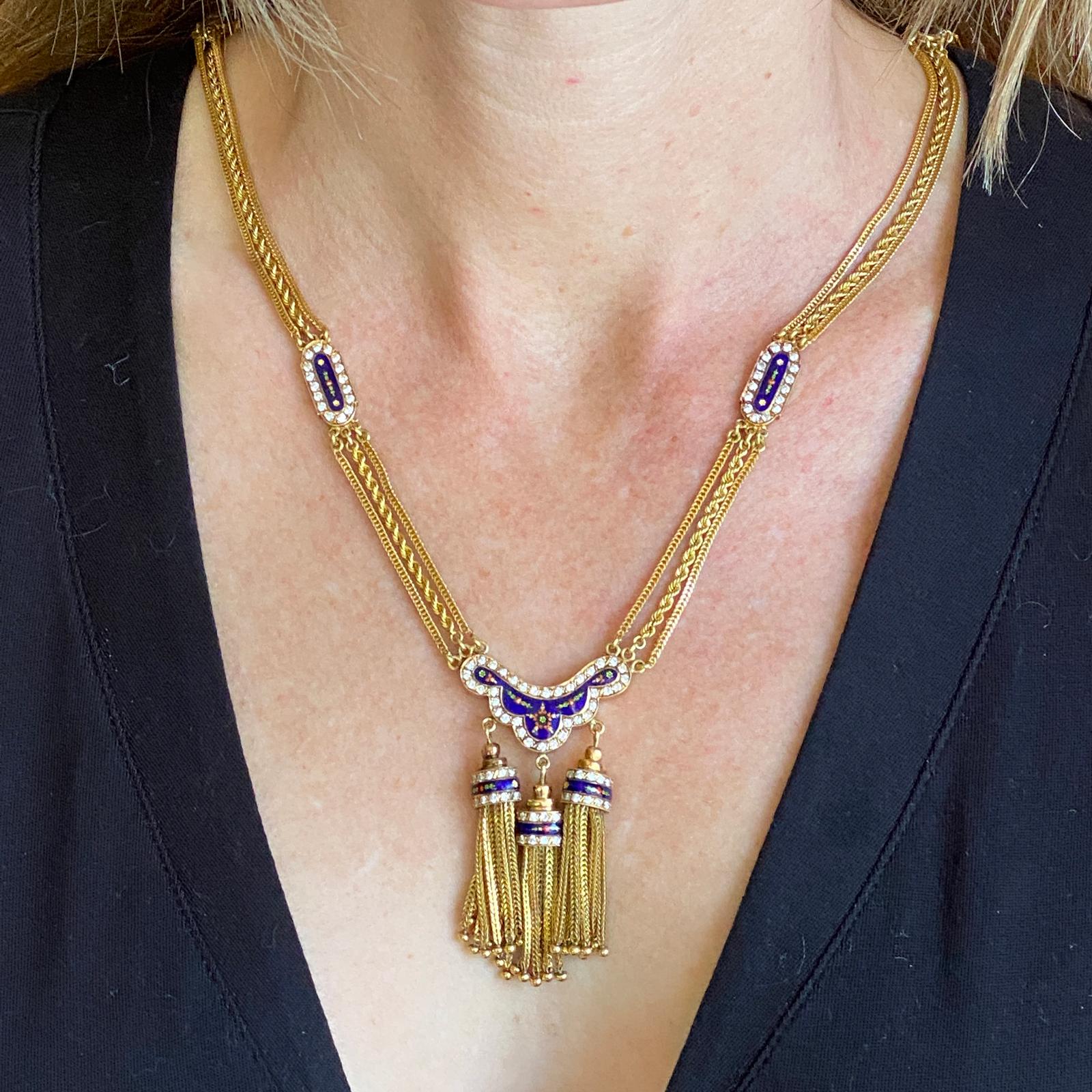 1950's diamond blue enamel tassel necklace fashioned in 18 karat yellow gold. The solid gold three strand necklace measures 22 inches in length, features 4 diamond enamel stations, and a center diamond enamel 3 tassel drop ( 2 inches in length). The