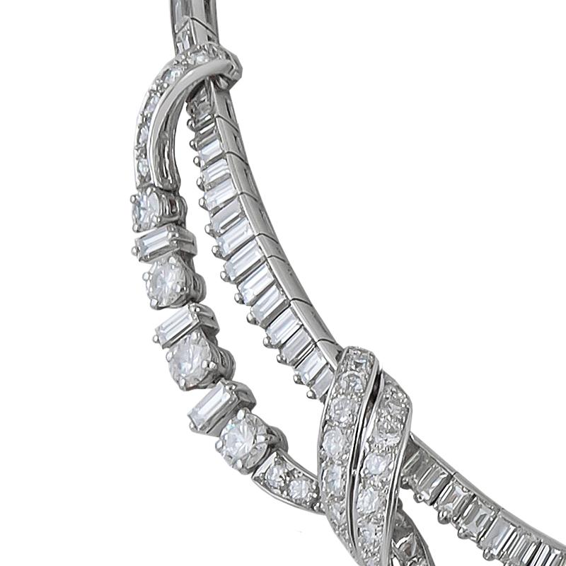 A very fine diamond fringe necklace, designed as a collar of vertically set baguette diamonds with a fringe of alternating brilliant-cut & baguette diamonds; the central stone weighing approximately 1.45 carats, and accented with diamond-set ribbon