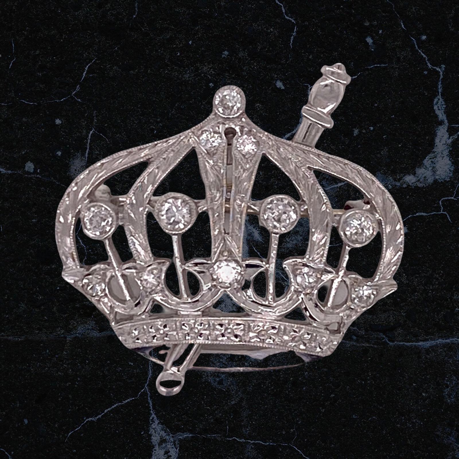 1950's diamond crown pin fashioned in platinum. The brooch features 12 transitional cut diamonds weighing approximately .90 carat total weight and graded H-I color and SI clarity. The brooch measures 1.00 x 1.25 inches. 