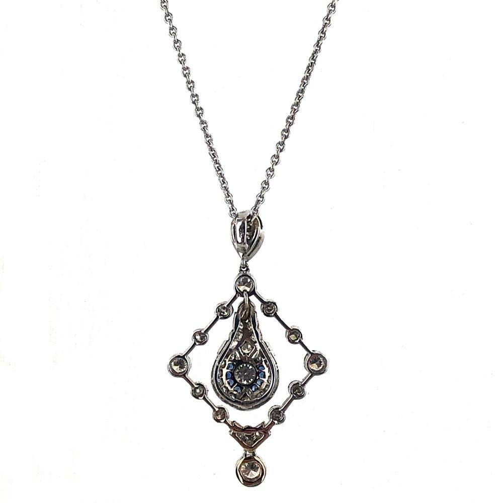 Diamond drop pendant circa 1950 is fashioned in 18 karat white gold. The pendant is handcrafted with 1.00 carat total weight of old european and transitional cut diamonds. The center features sapphire accents. The necklace measures 18 inches in