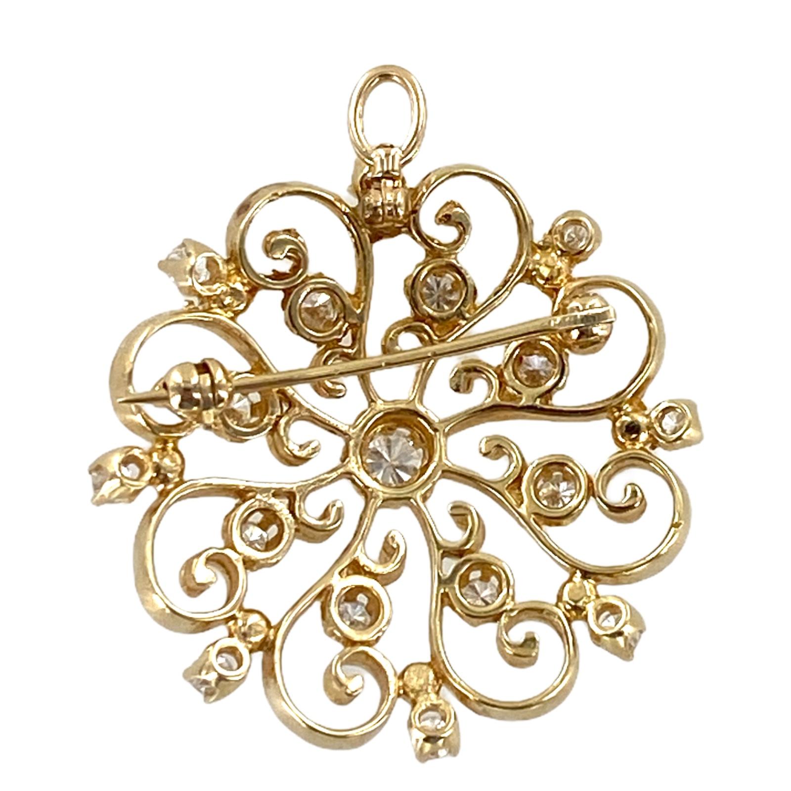 1950's diamond starburst pendant and pin fashioned in 14 karat yellow gold. The brooch features 17 round brilliant cut diamonds weighing approximately .85 carat total weight and graded H-I color and SI clarity. The starburst has a retractable baile