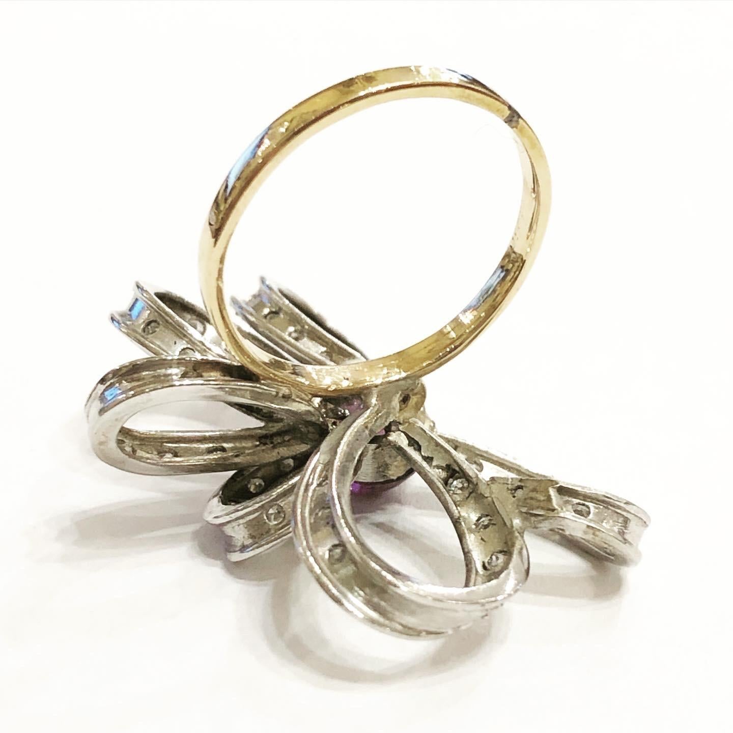 1950s Diamonds Amethyst Platinum 18k white gold cocktail ribbon ring.
Ring in platinum and 18 karat yellow gold.
Superb fashion ring, ribbon design typical for this period.
Circa 1950.
Brilliant diamond cut.
Cabochon amethyst cut.
Total weight of