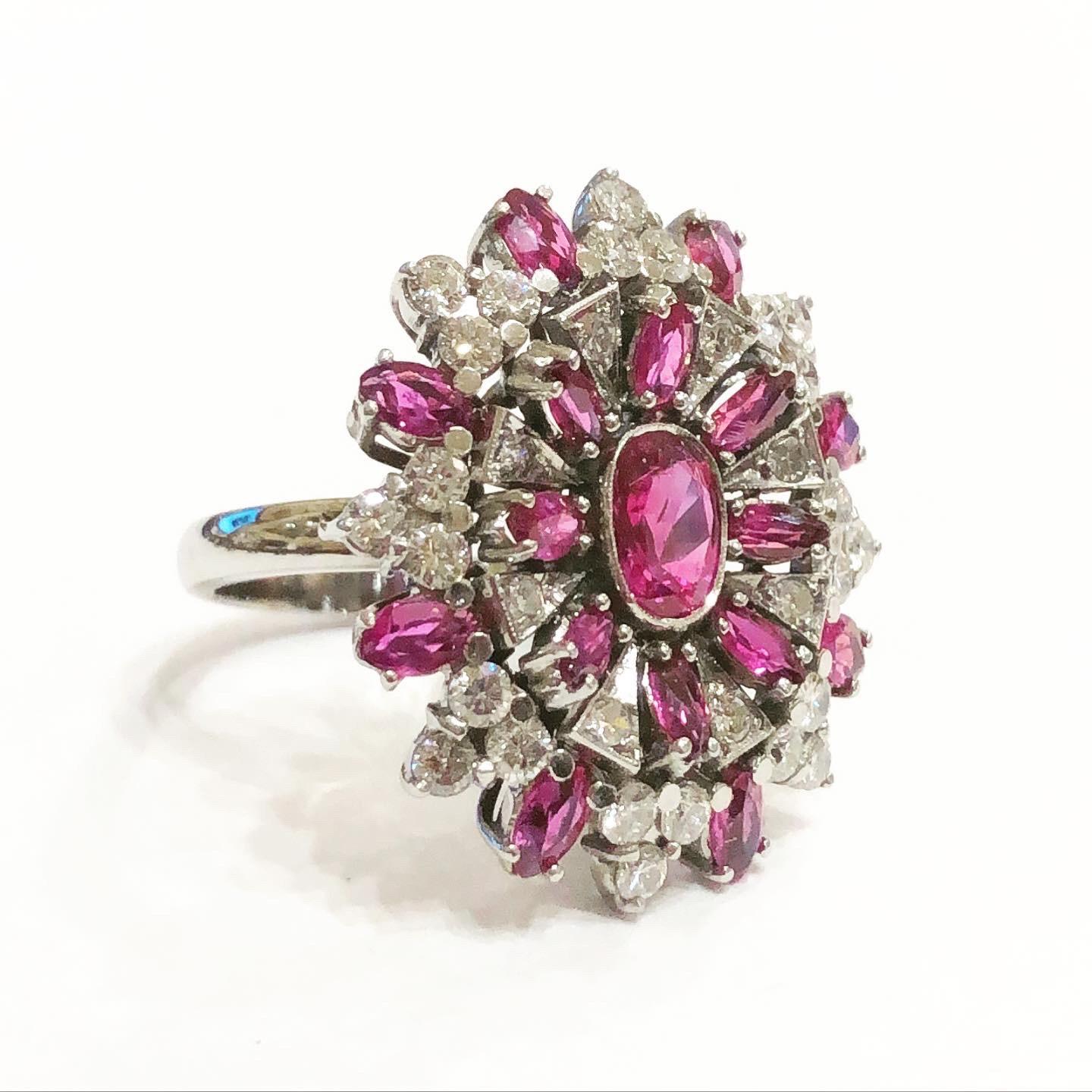 1950s diamonds rubys white gold cocktail ring.
Condition:Good.. 
18 karat white gold.
Oval cut rubys.
Brilliant cut  diamonds.
Diamond approximate carat weight: 0.9 carat.
Ruby approximate  weight: 3 carat.
Size: 6.75. It can be resized.
Height: 