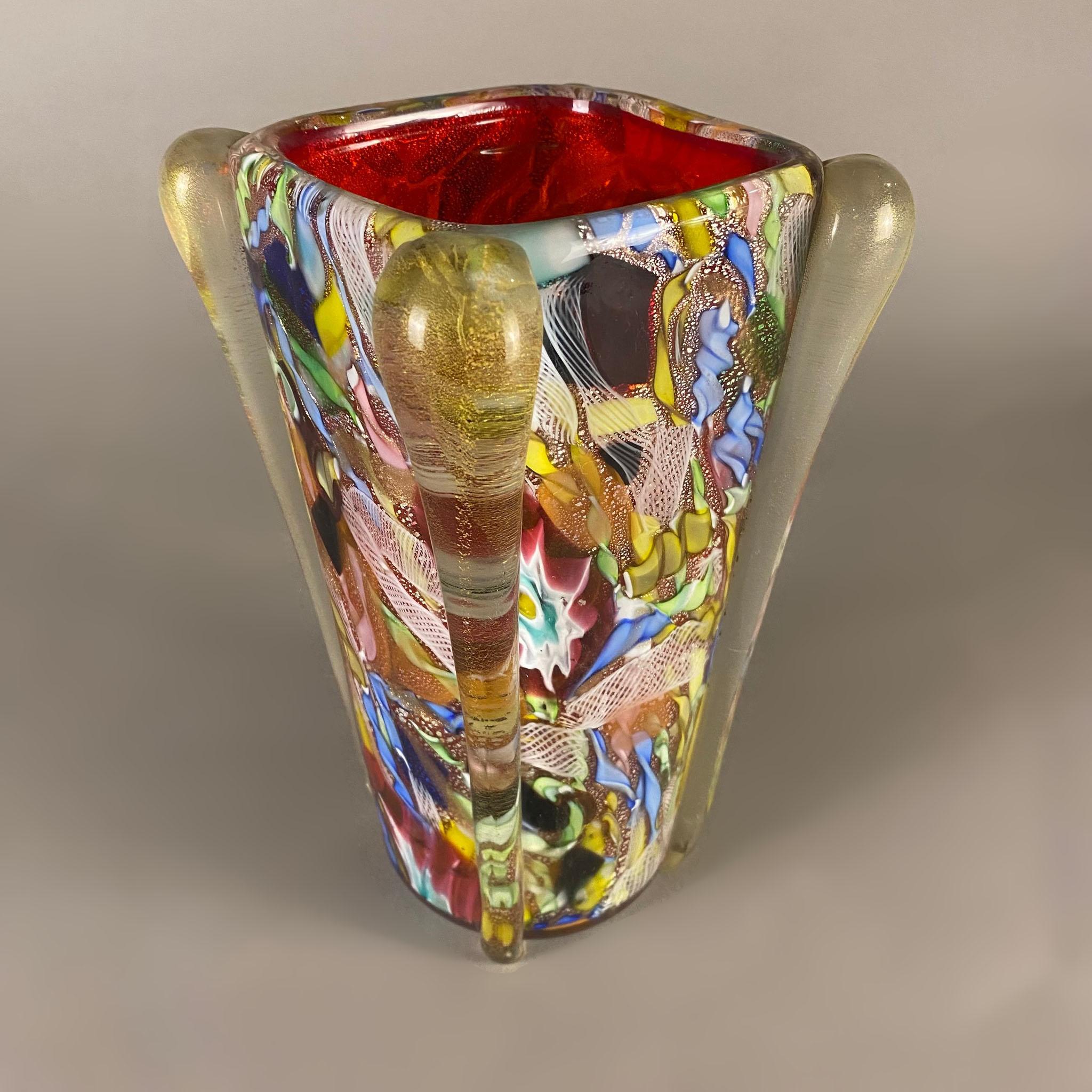 A 1950's Italian blown Murano large flower vase by Dino Martens. The multi-color vase has a squared shape with rounded angles and silver leaf applications in the colored glass.

Corrado 